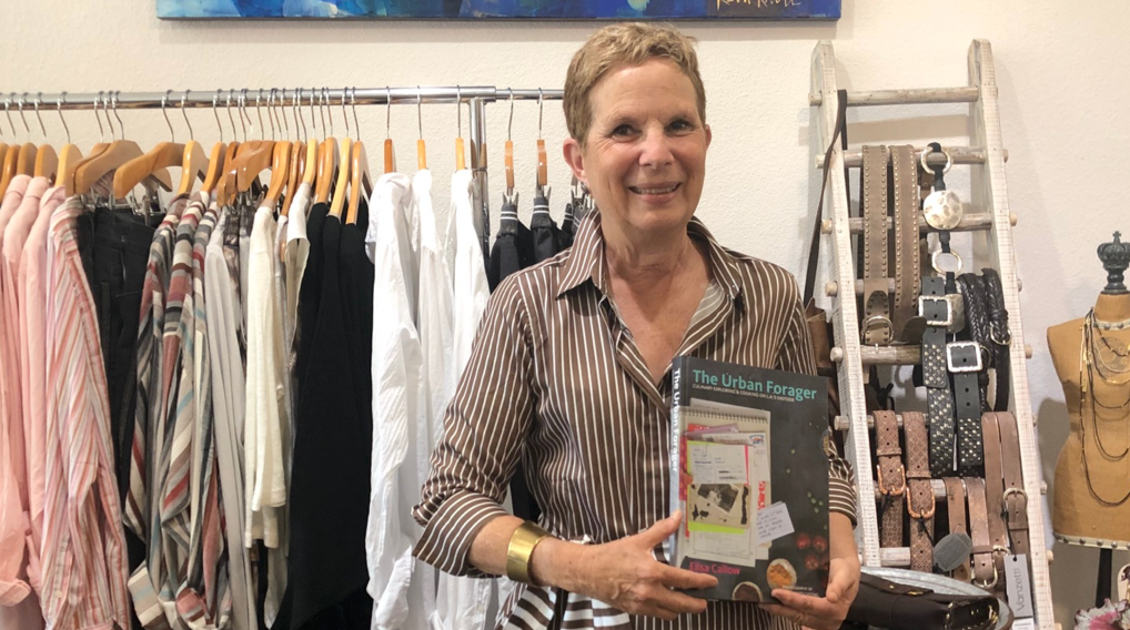 Elisa hanging out at Tuck wearing one of their gorgeous dresses and a cuff with a favorite cookbook.