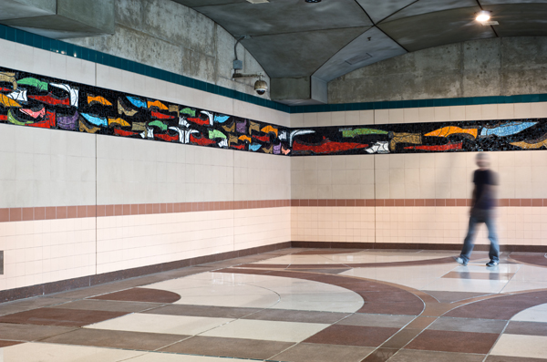 Tyree Guyton designed this artwork to evoke thought, create conversation and stimulate the observer to think about the most basic mode of transportation - the shoe. Guyton explores the power of transportation by examining movement through shoes as a metaphor of shoes representing individuals; all colors, styles, shapes and all moving in different directions. 