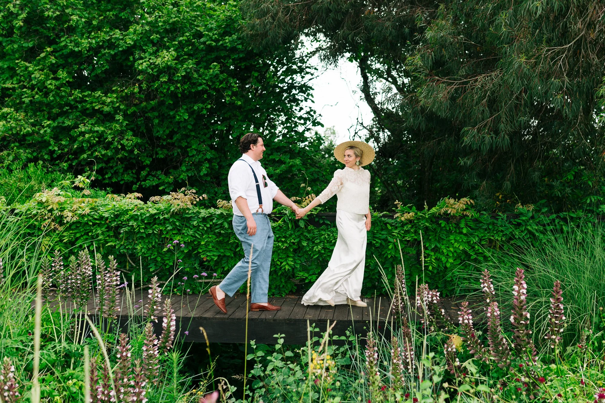 American bride and groom couple taking a walk in the gardens of Chateau Rigaud, luxury destination wedding venue near St Emilion in Bordeaux, France