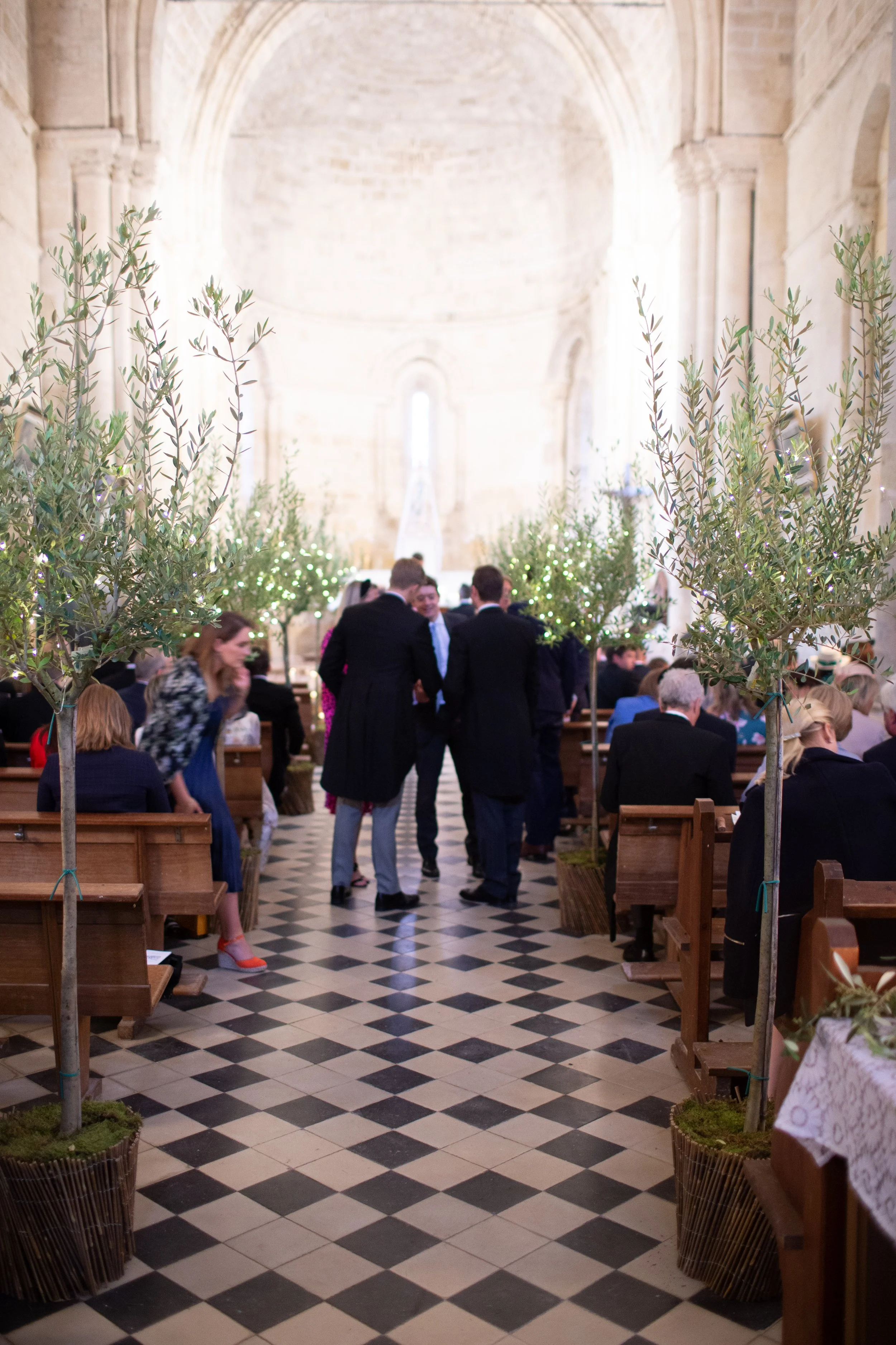 Church ceremony at Chateau Rigaud in Bordeaux. Olive trees line the asile
