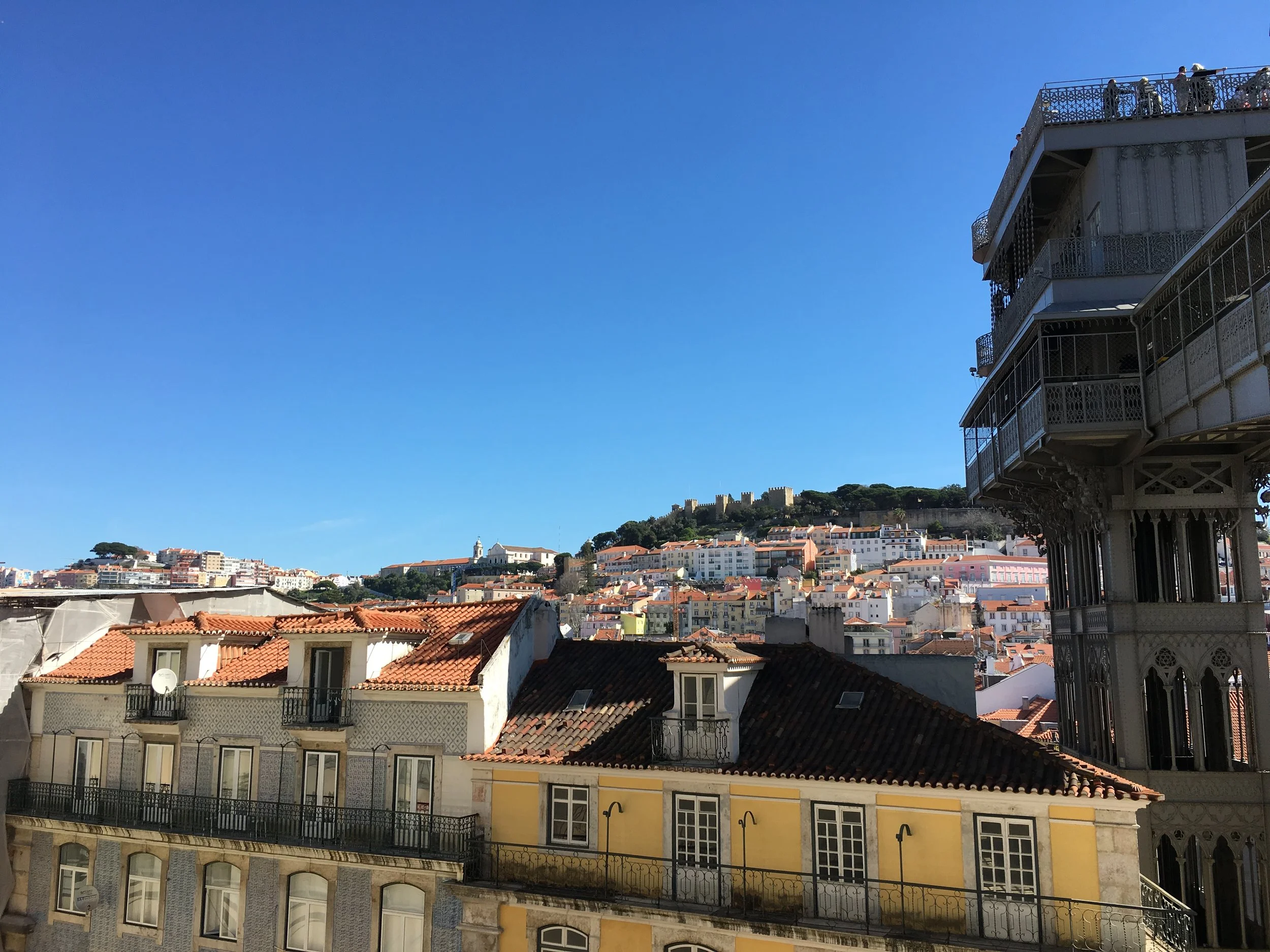 Views from Igreja do Carmo over Lisbon’s tiles rooftops and the São Jorge castle. The neo-gothic lift - Elevador de Santa Justa to the right.