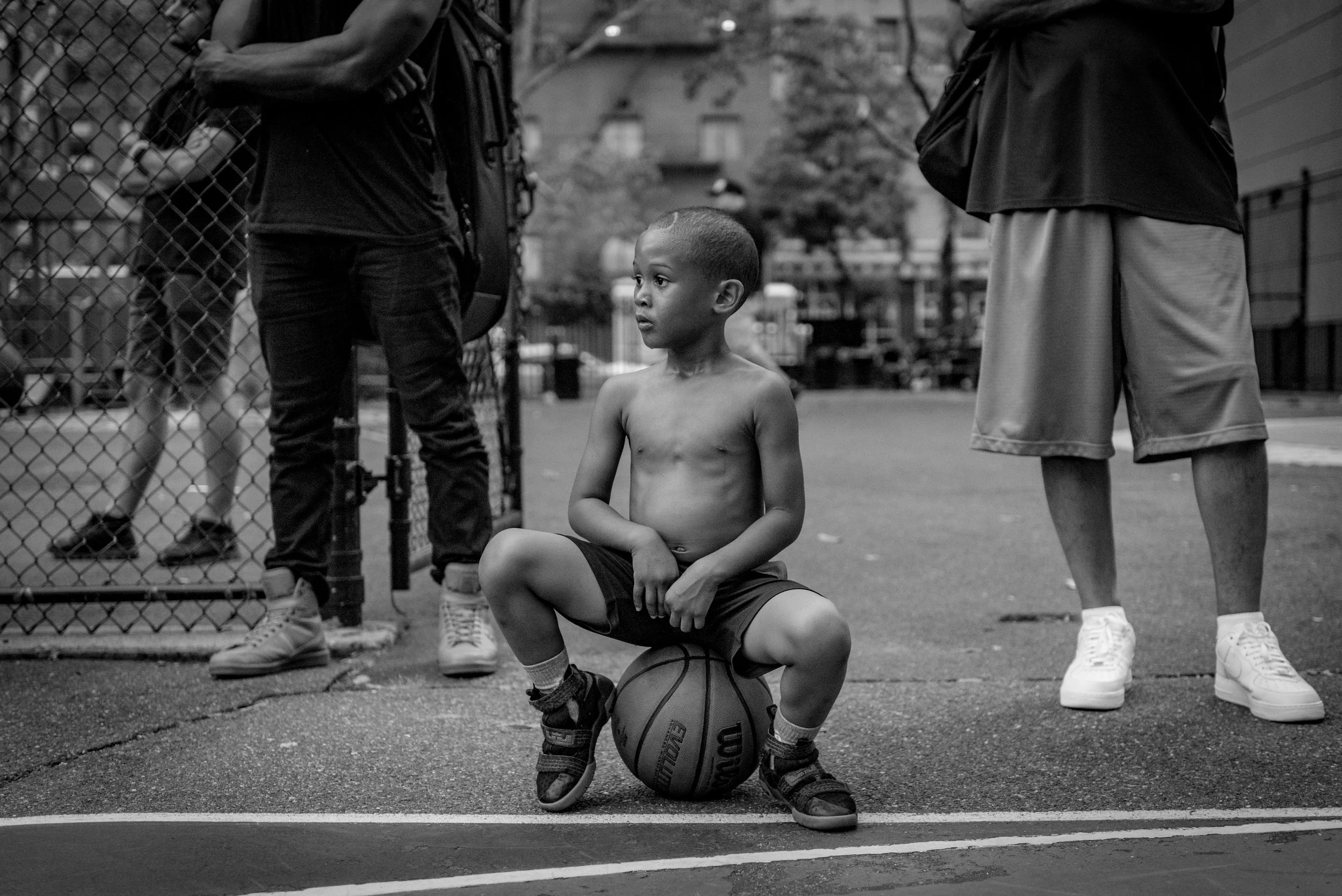 Young Boy Watches Basketball Tournament in Upper East Side