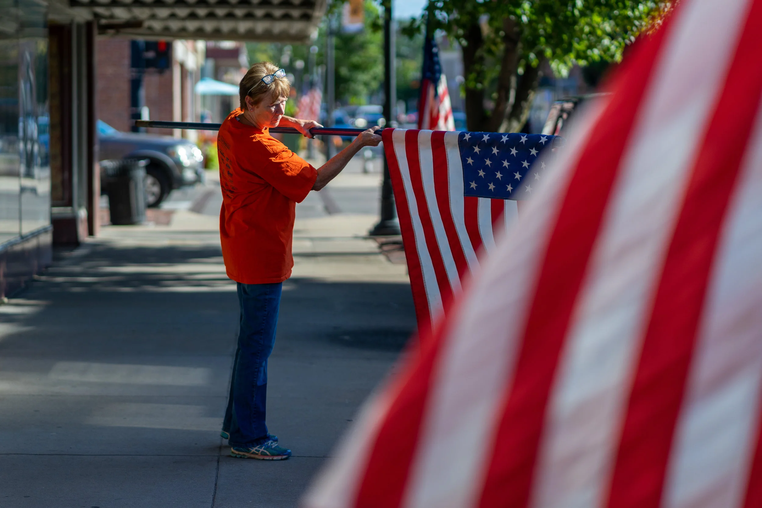 One of Laura Vollmer's daily rituals is to put out her American flags on Main Street, Its a sign of pride and also to inform anyone driving by she is open for business.