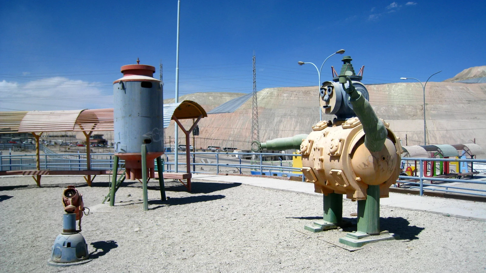 Whole communities have been supplanted by the encroachment of overburden from the mine, the tailings piles behind this playground move closer with every day.