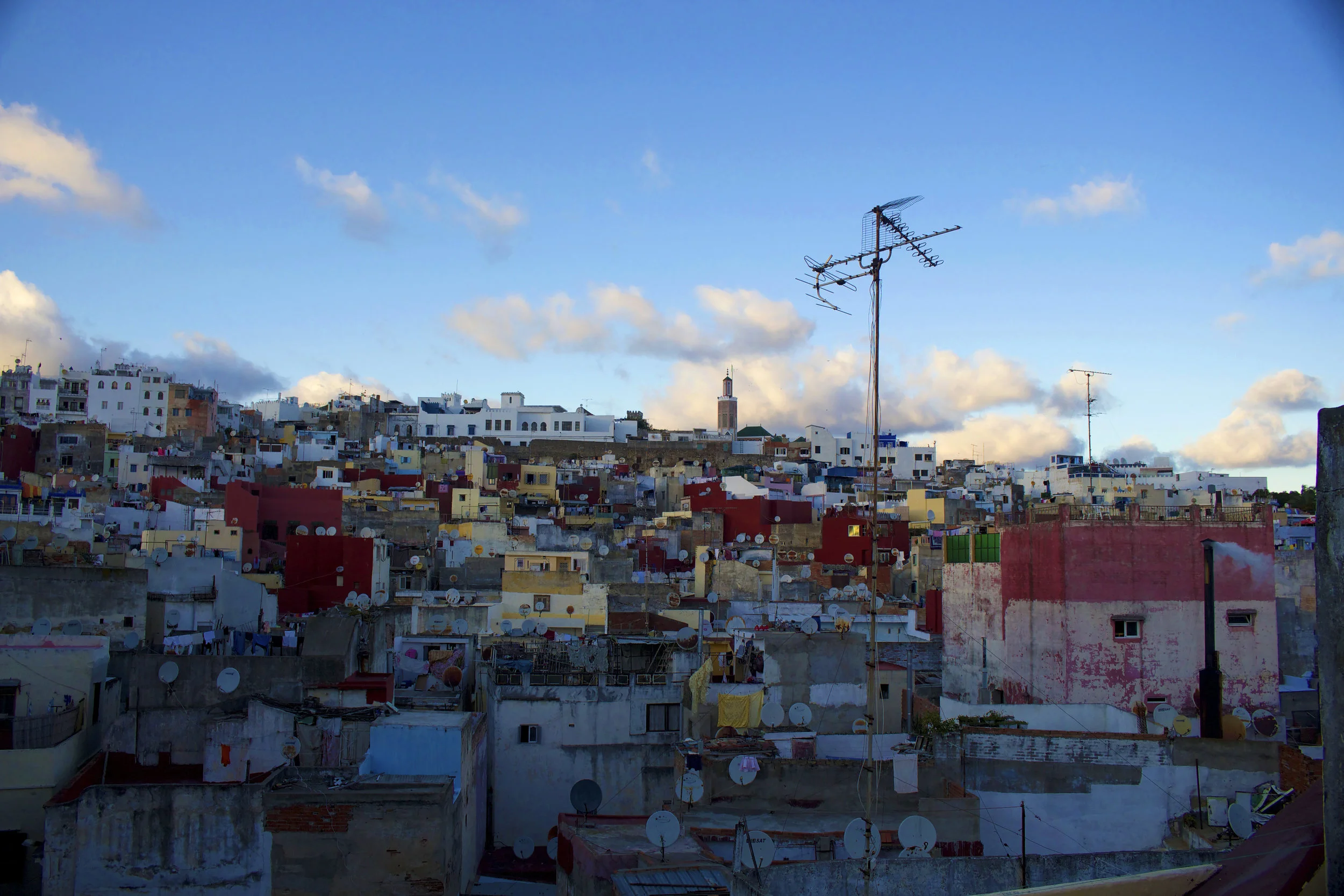  A sprawling view of the Tangier medina. Smoke rises from bread ovens, laundry hangs from roof-to-roof, and the echoes from the call to prayer reverberate throughout the concrete labyrinth. 