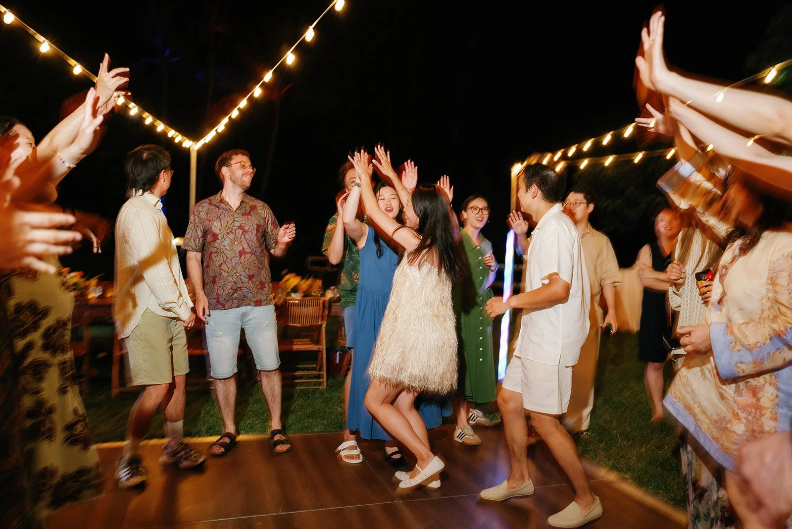 Bride and groom share a fun moment on the dance floor with their guests