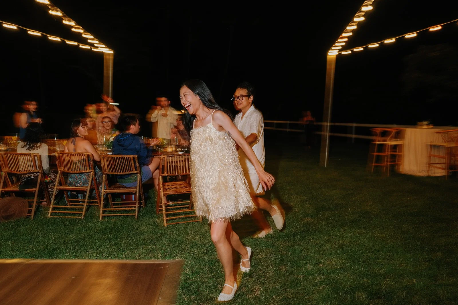 Bride and groom run to dance floor to start their first dance
