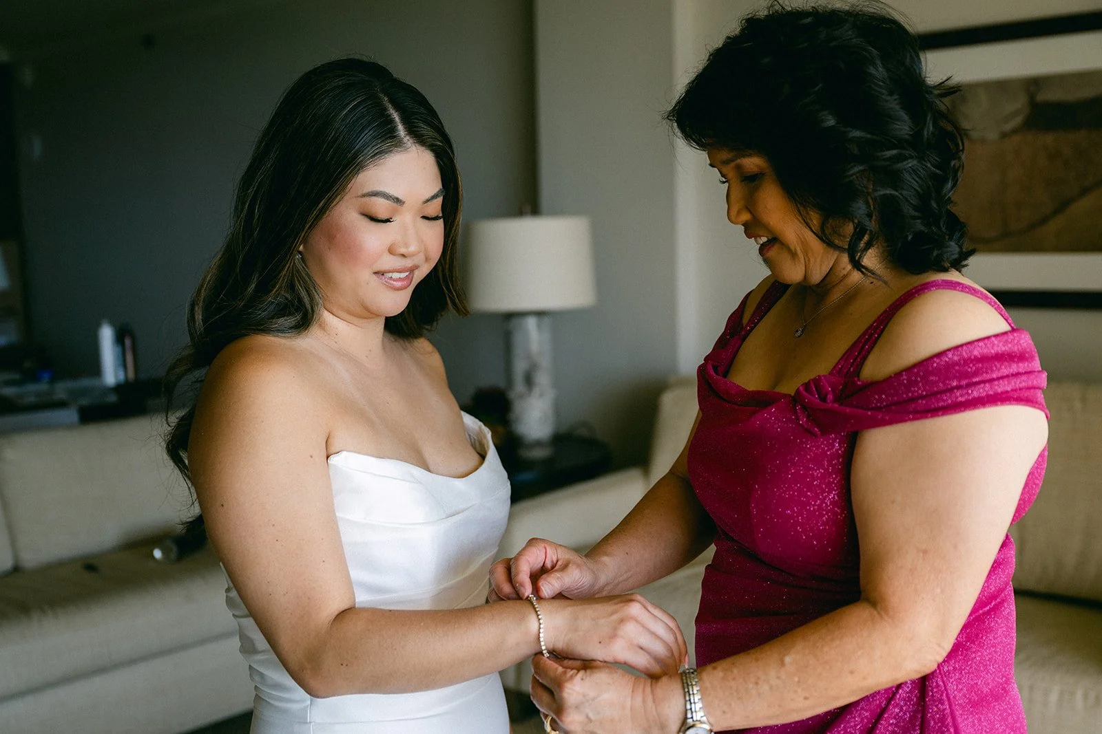 bride's mom helping her get ready
