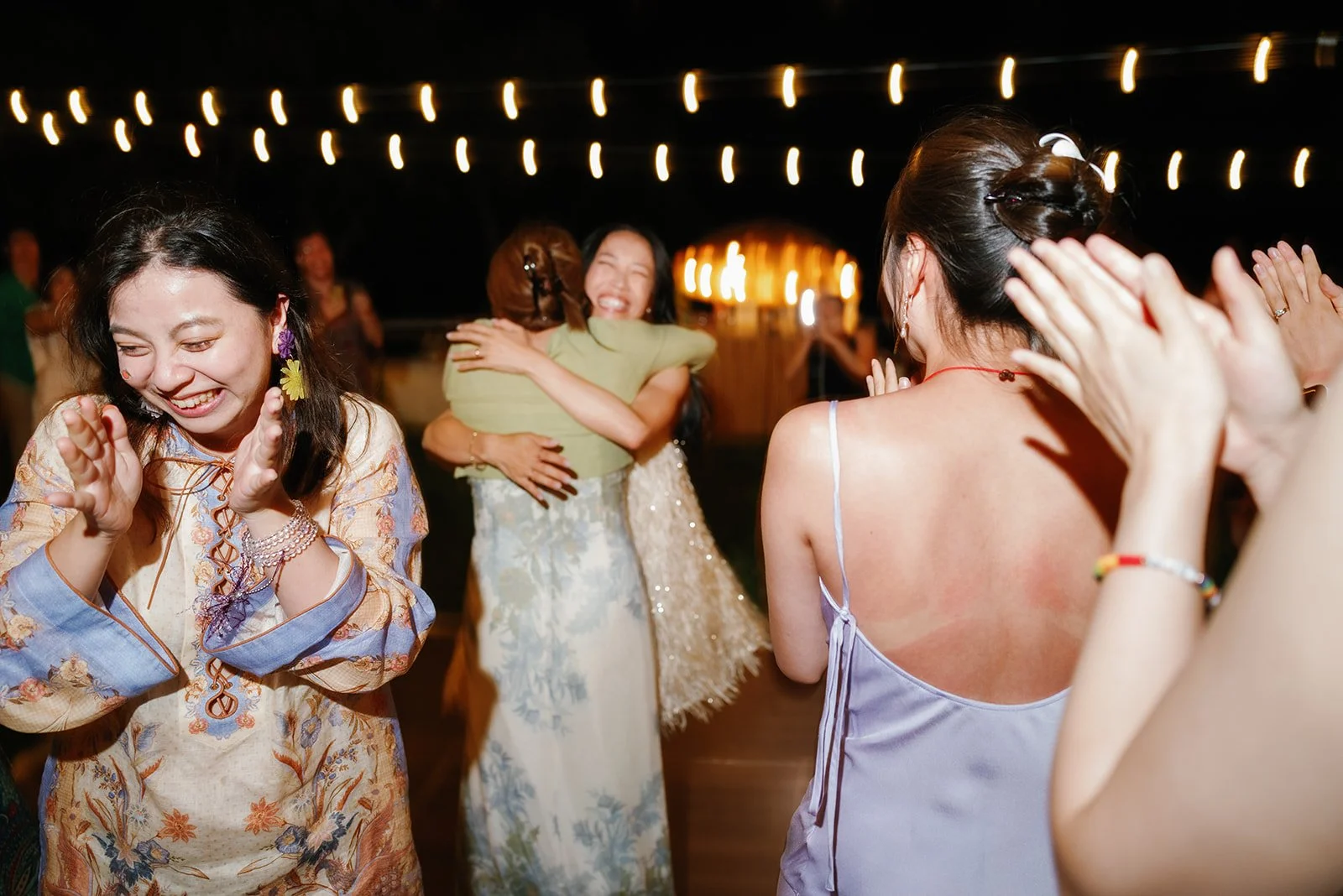 Bride hugging the  that caught the bouquet