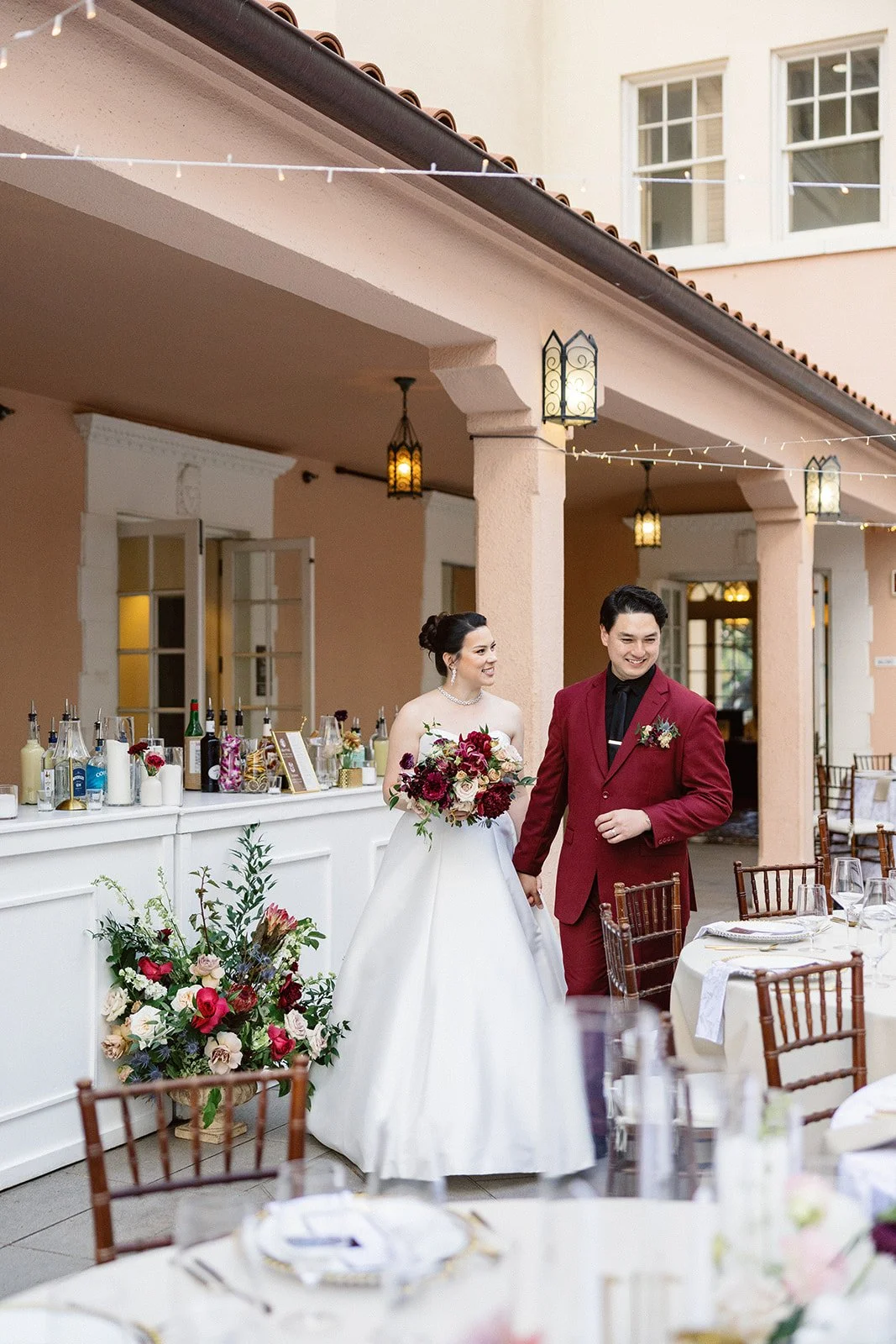 Bride and groom enjoying walking through their dinner reception set up
