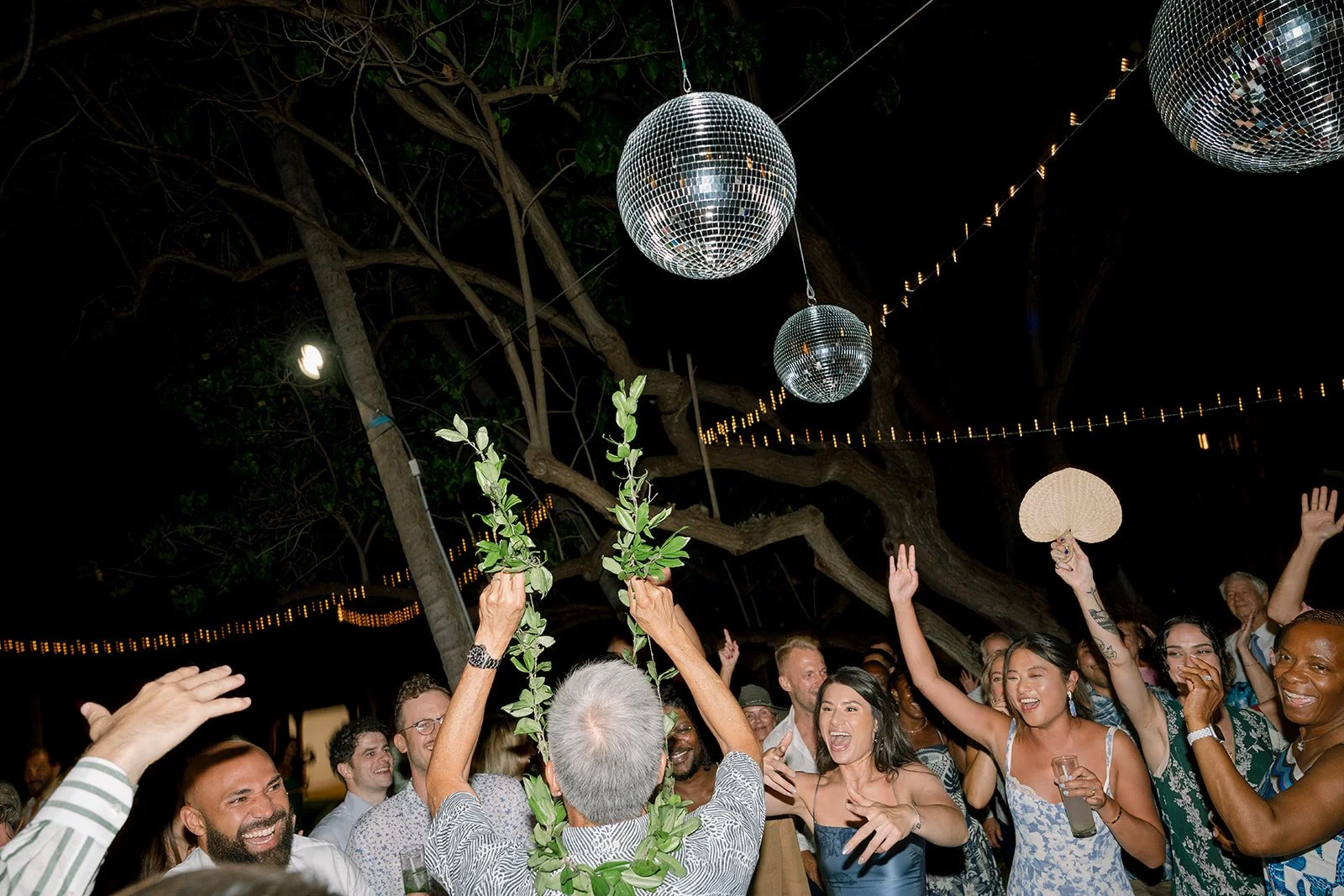 wedding guests dancing under disco balls