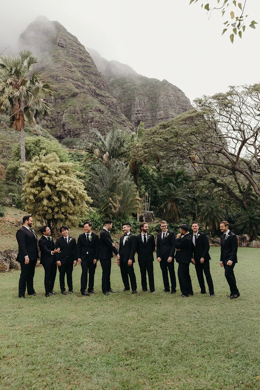 groom with groomsmen in front of mountains in hawaii
