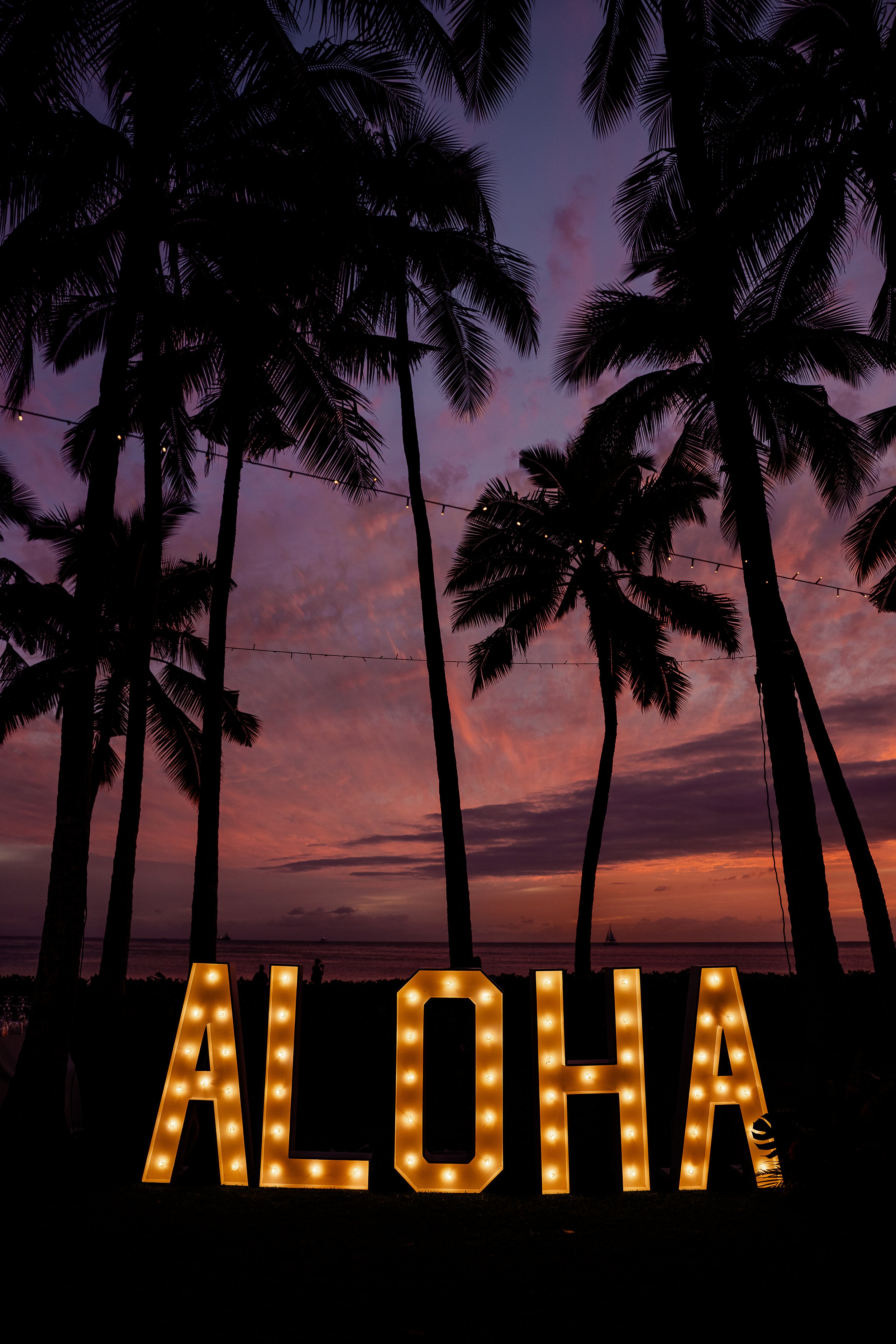 Sunset in Hawai'i with aloha marquee sign
