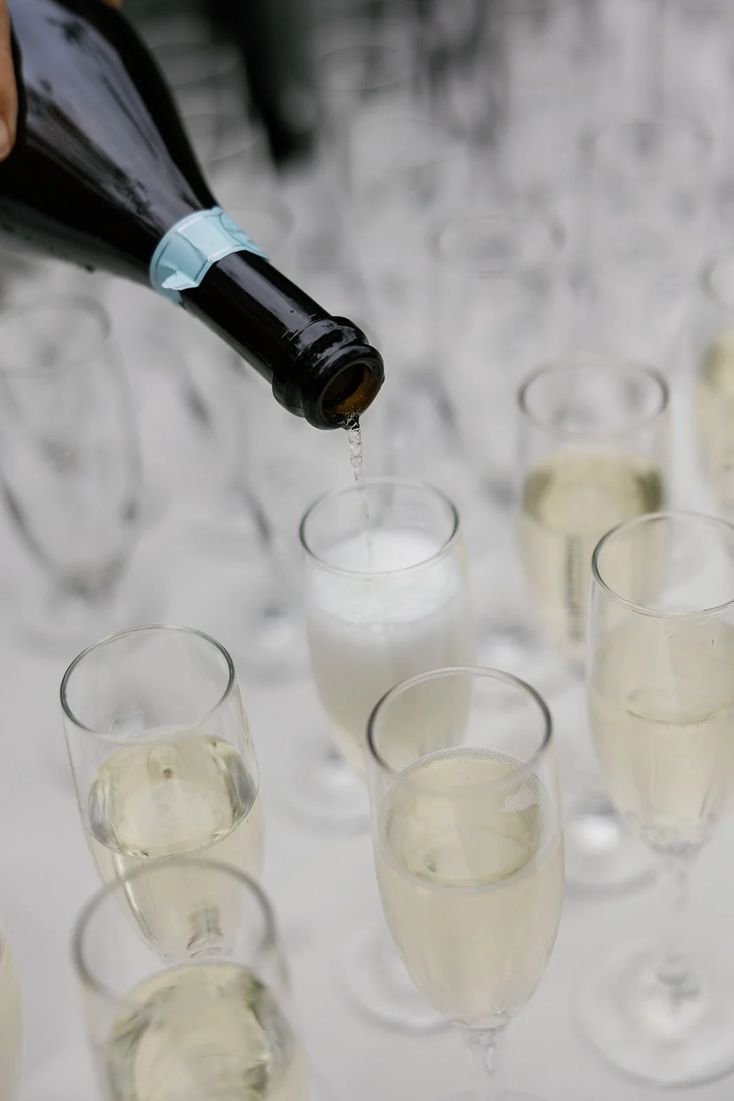 Champagne poured for welcome pass before ceremony at Paliku Gardens wedding in Hawaii