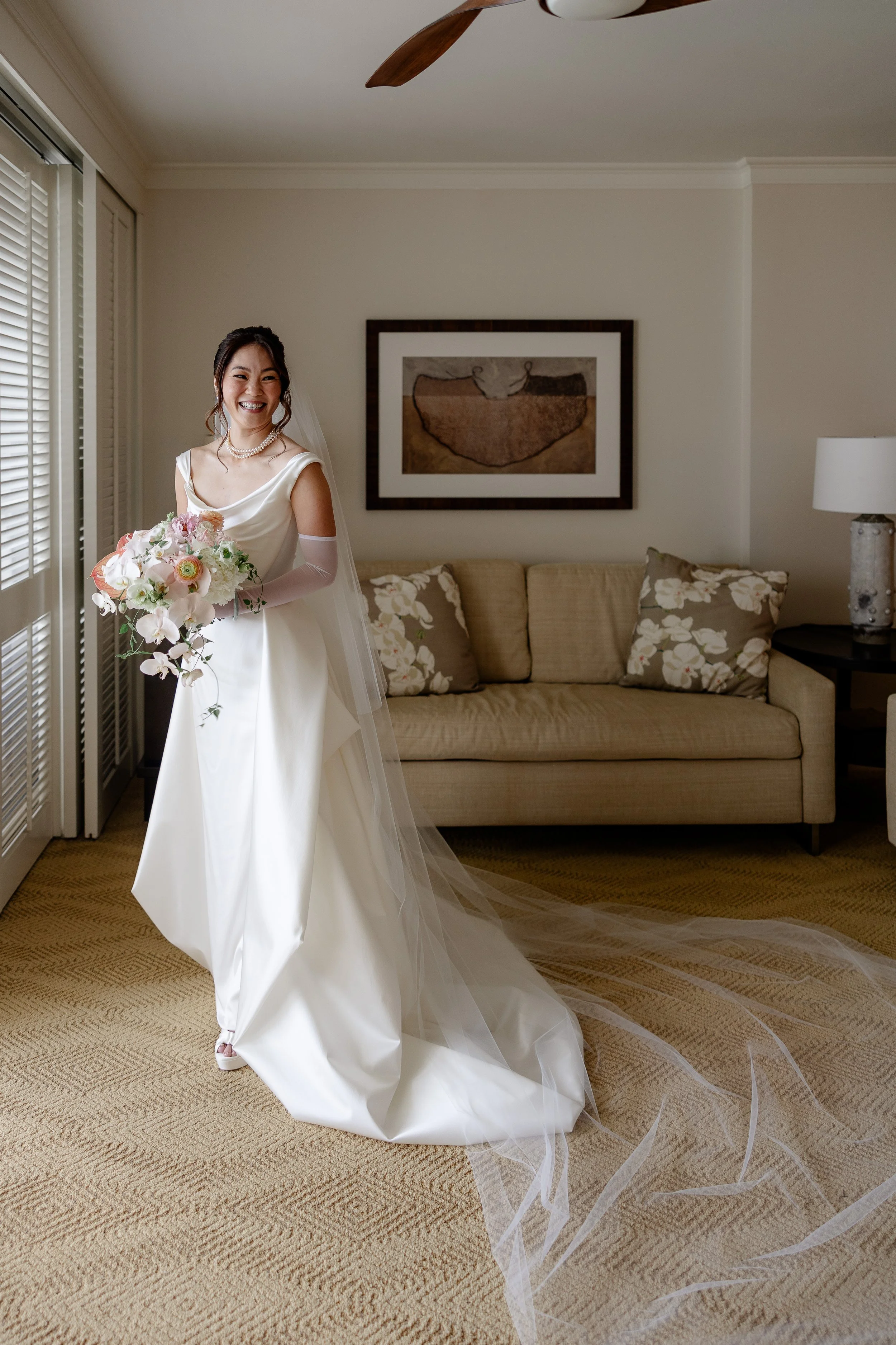 bride smiling while holding flower bouquet