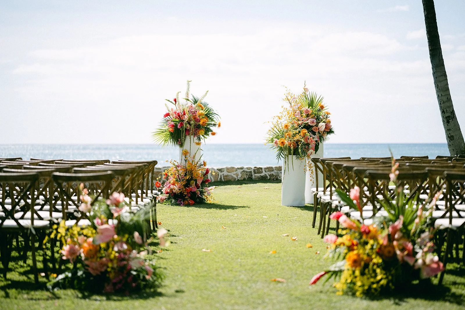 wedding ceremony on beach in hawaii with colorful flowers