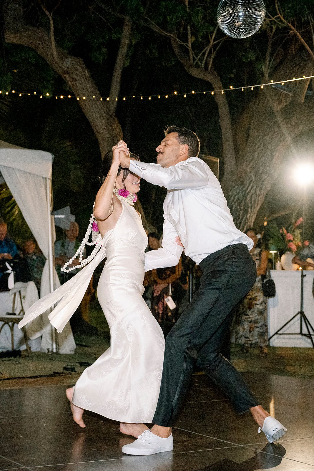 bride and groom dancing with lei