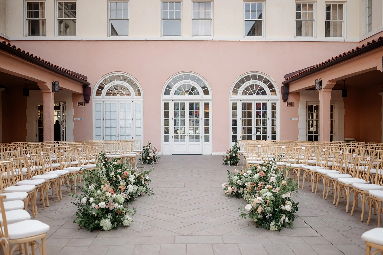 wedding ceremony at museum with pink and mauve flowers