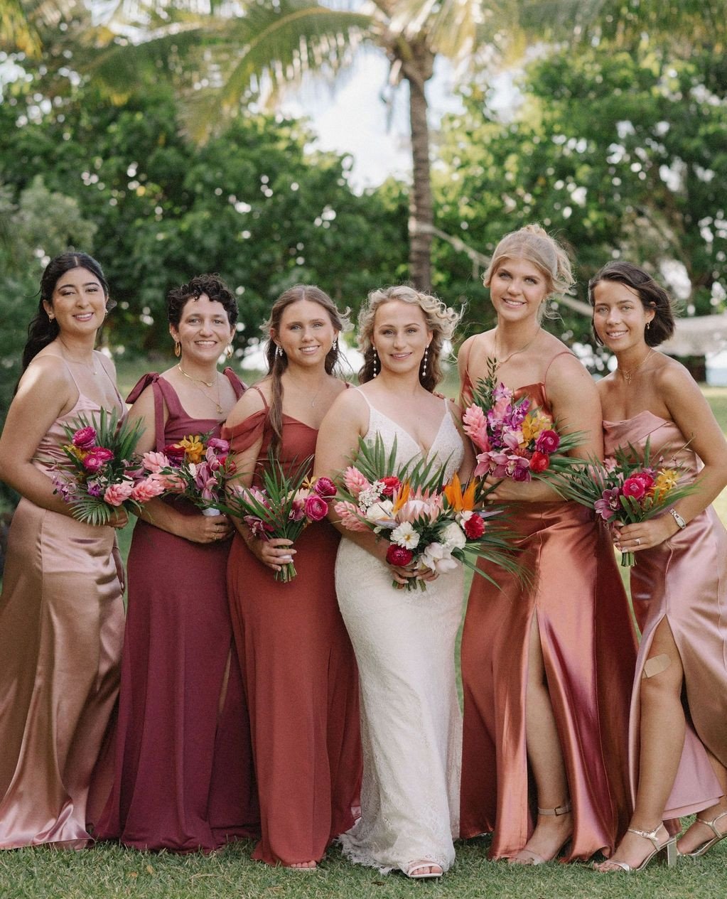 As you may have learned by now, we're BIG fans of vibrant florals - and Hannah and Raffy's wedding day showcases one of our favorite palettes of tropical blooms and foliage - a trio of pink hues, yellow, orange and little hints of red, paired with wh