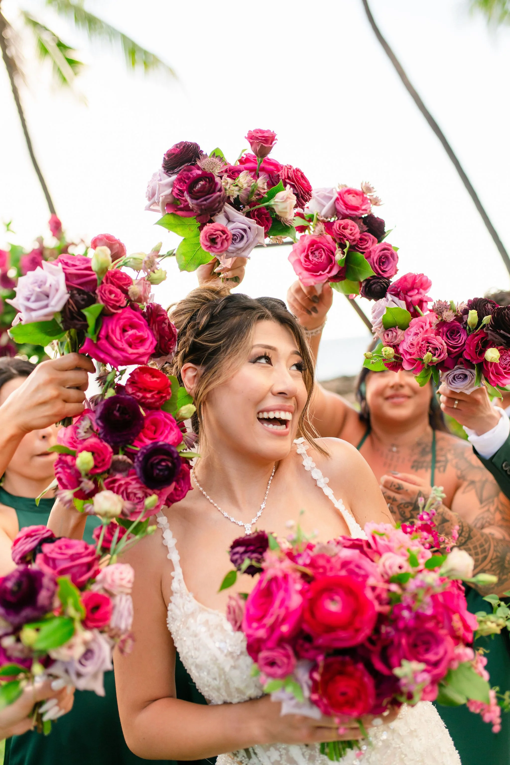 bride surrounded by bouquets