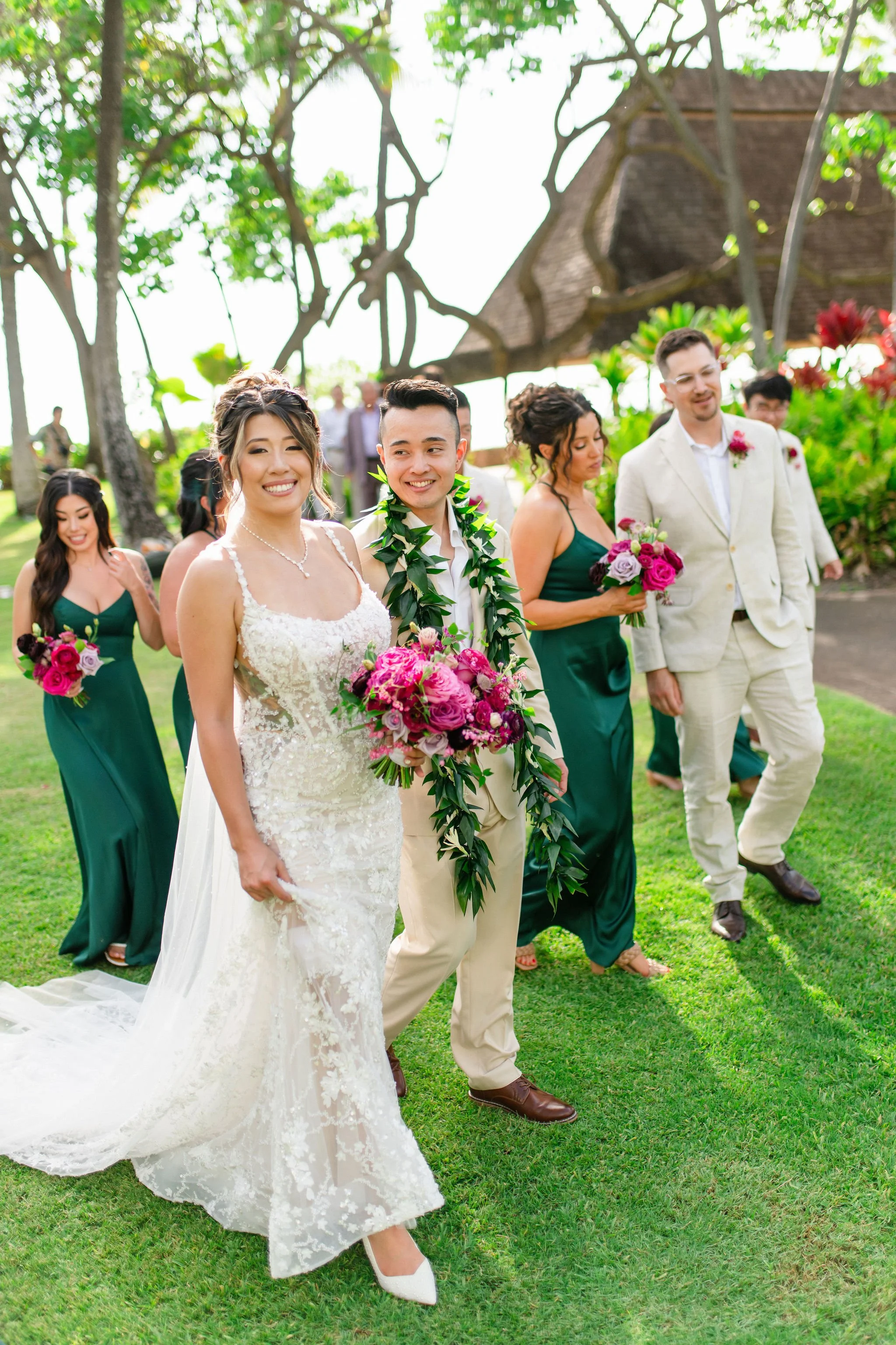 bride and groom walking with wedding party at hawaii wedding