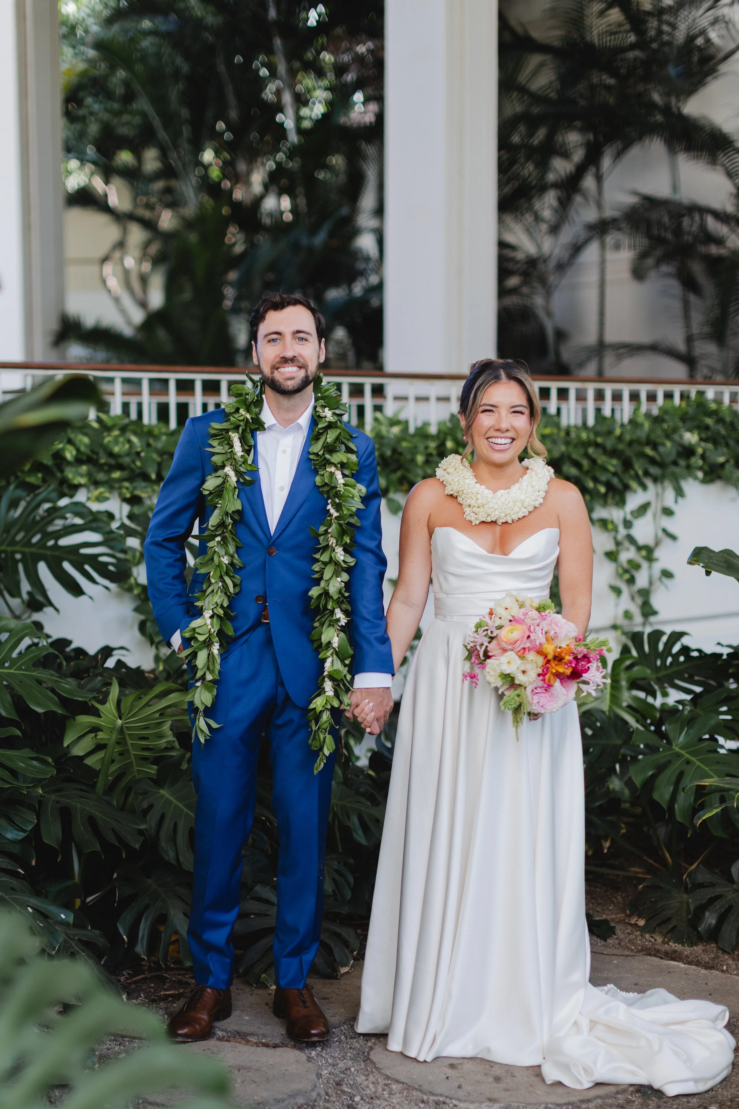 bride and groom with lei