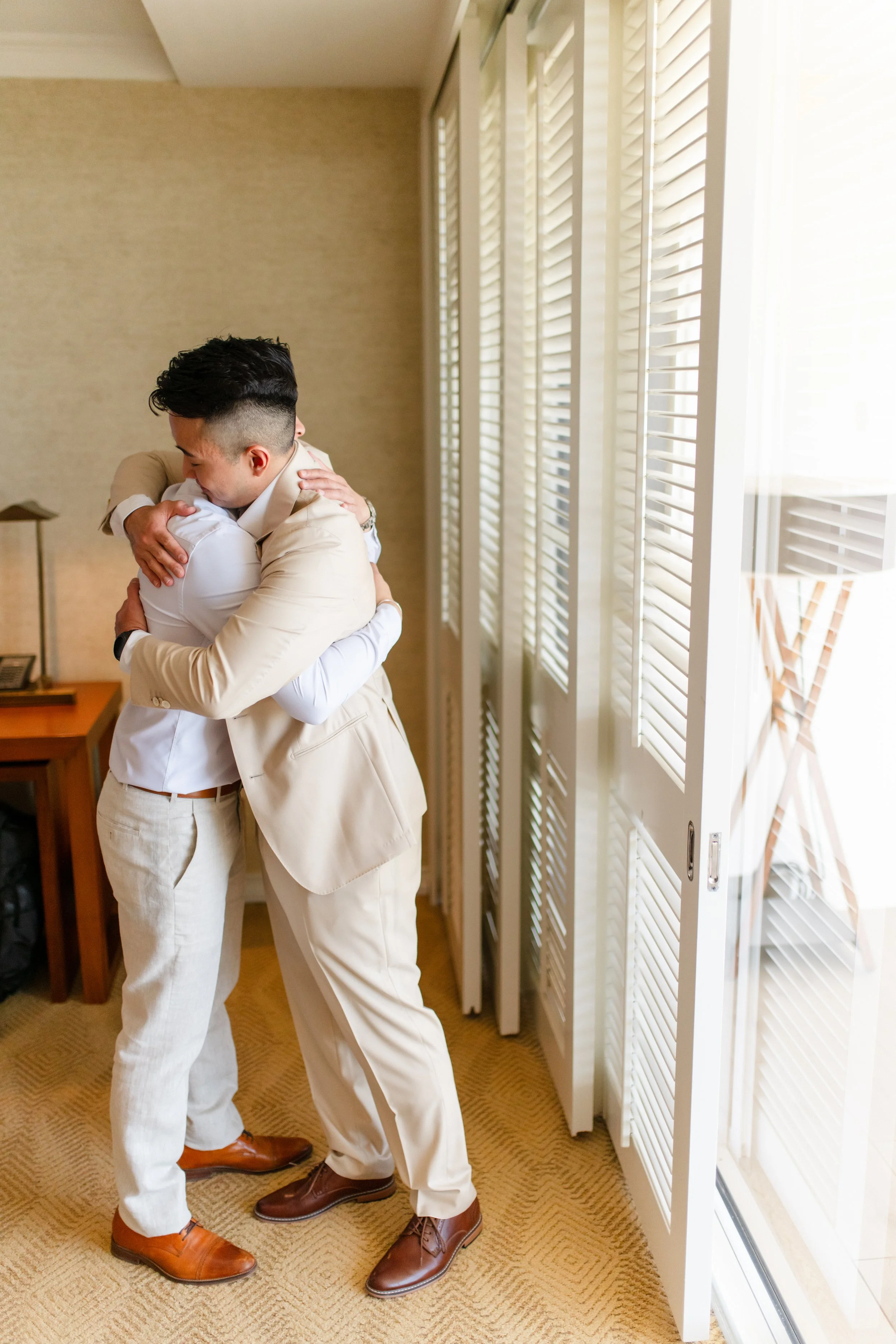 groom and groomsman hugging