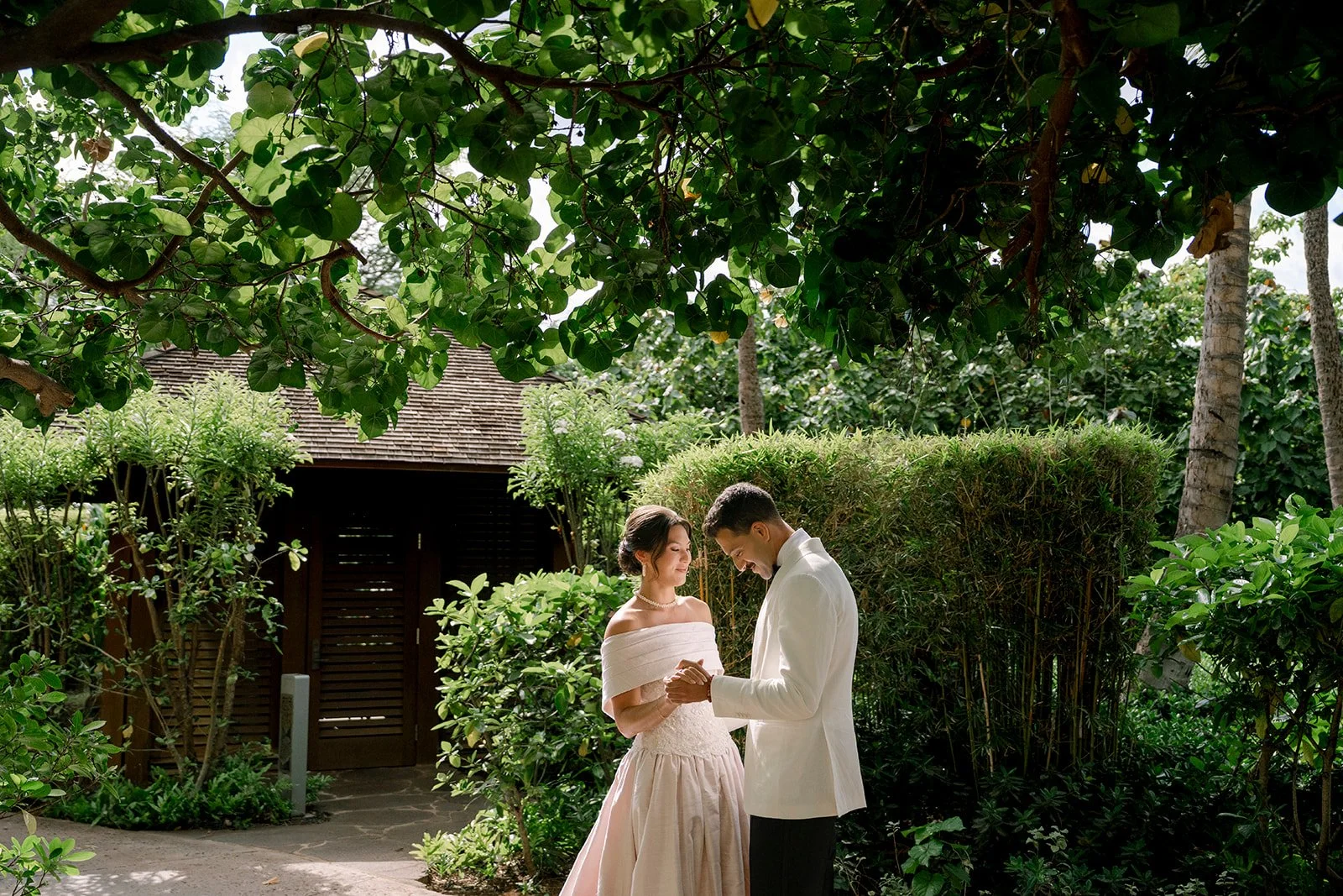 bride and groom in from of greenery