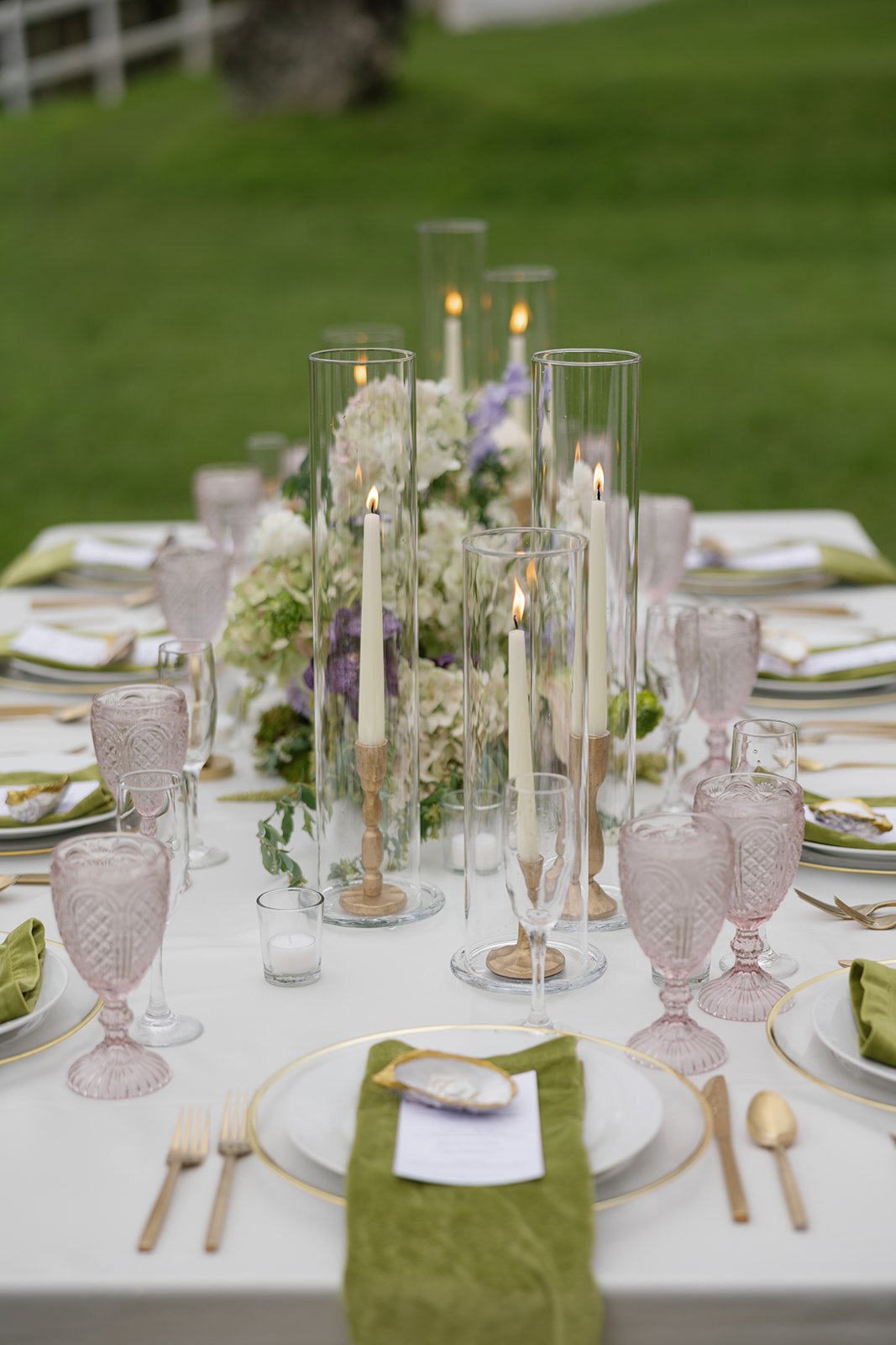 Hawaii wedding planner Love Letter Weddings styled this table with green, pink, purple, gold, and ivory place settings at Paliku Gardens