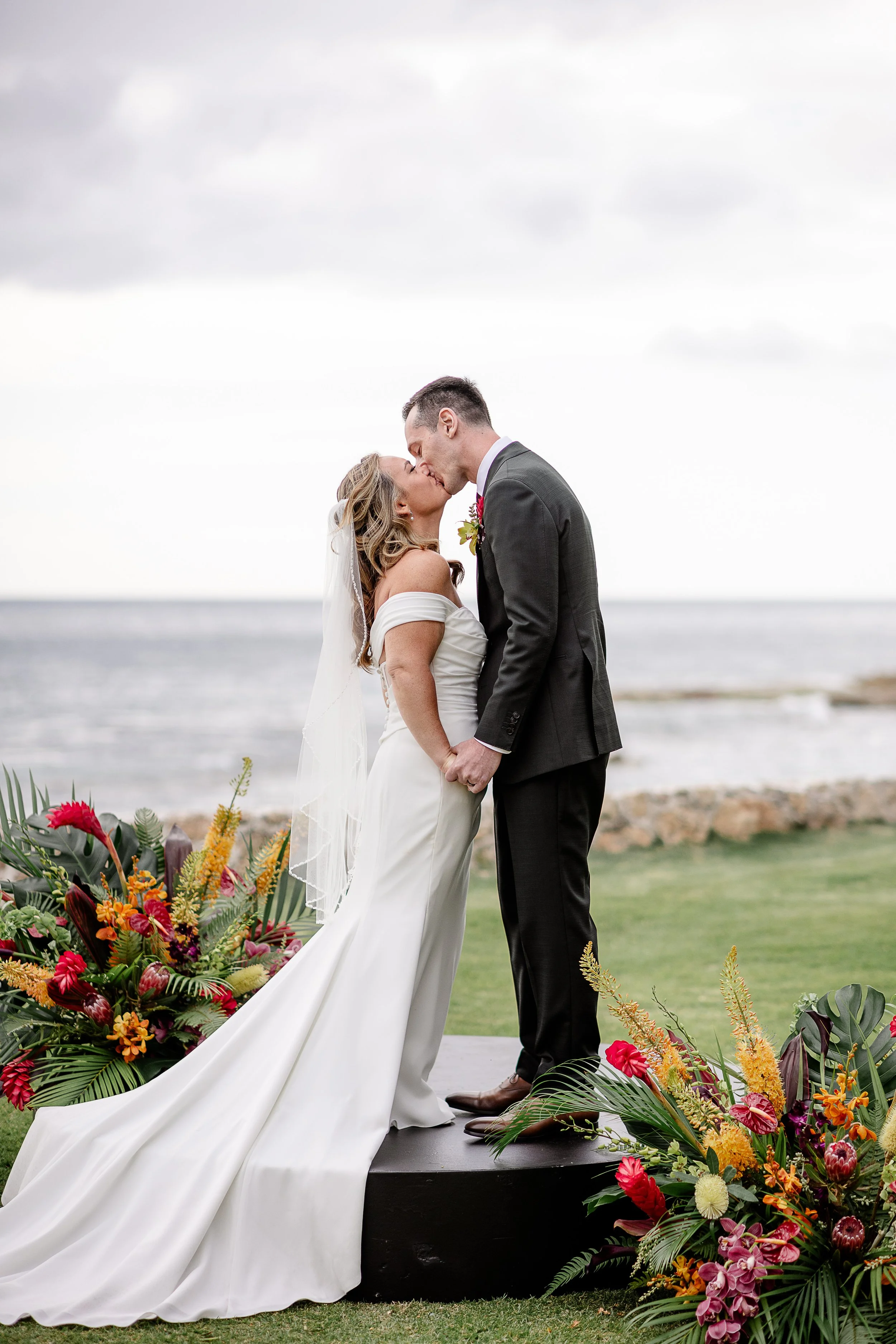 bride and groom kissing during wedding ceremony in Hawai'i
