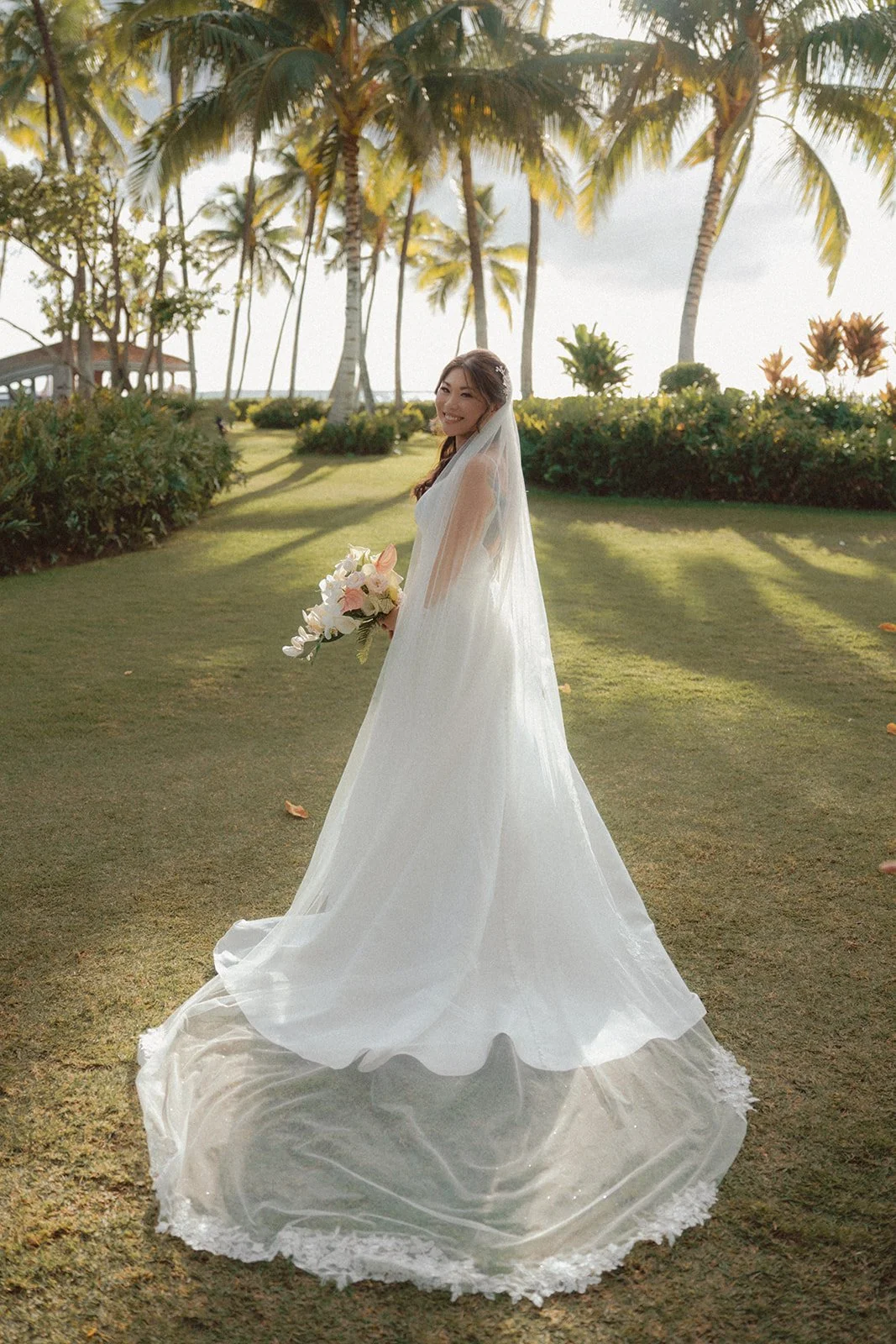 bride in front of palm trees in hawaii