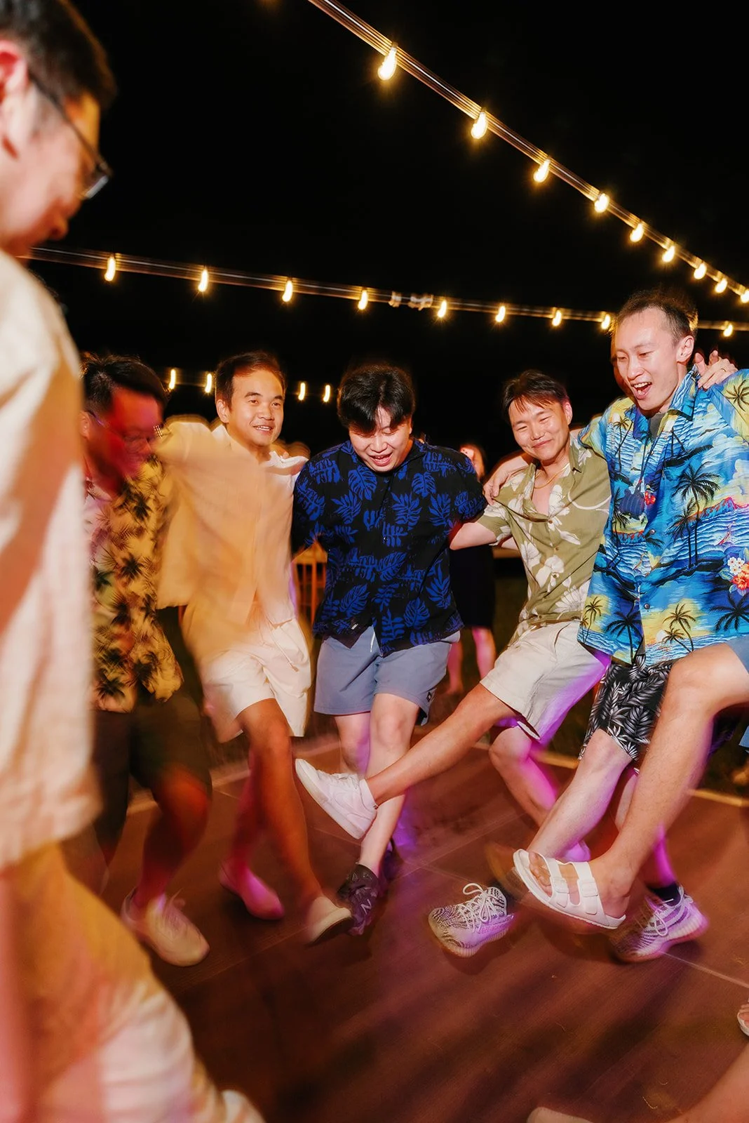 Groom dancing with family and friends on the dancefloor