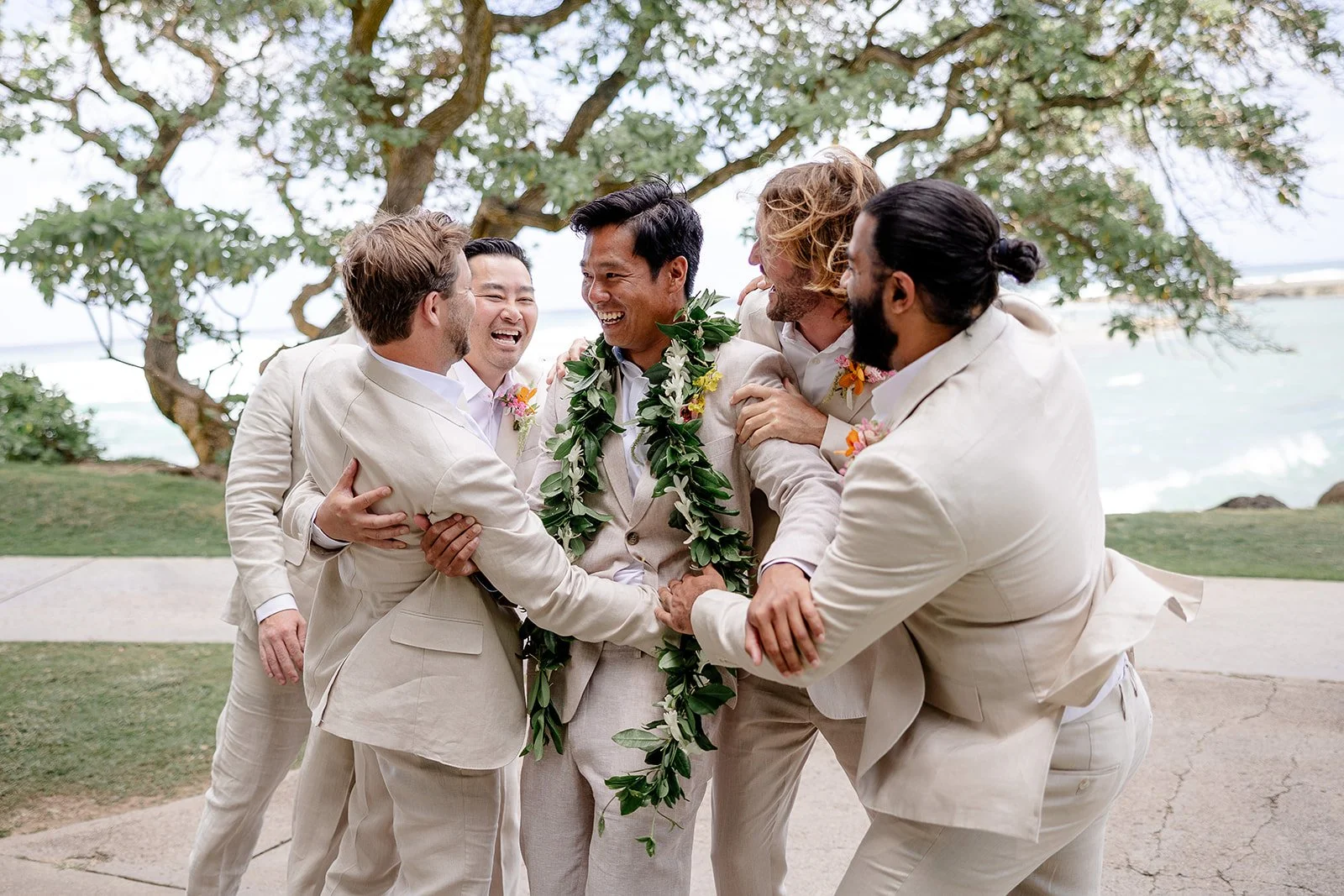 groom with groomsmen in tan suits