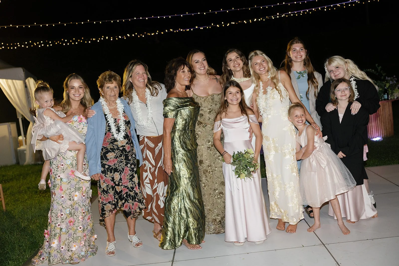 Bride poses with female relatives on the dance floor at this Paliku Gardens wedding, planned by Hawaii wedding planner Love Letter Weddings