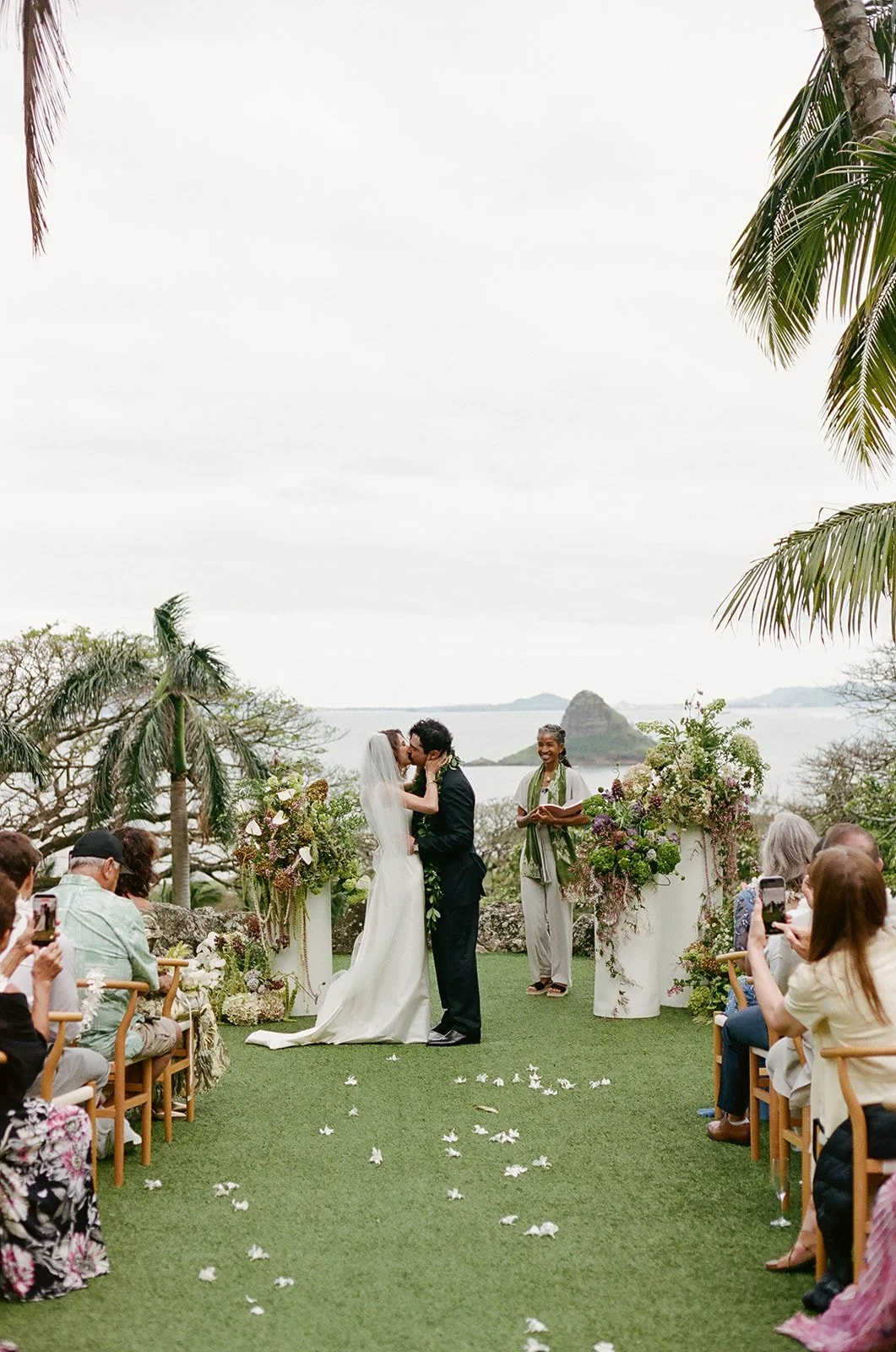 Bride and groom first kiss at Paliku Gardens Hawaii wedding ceremony on Oahu