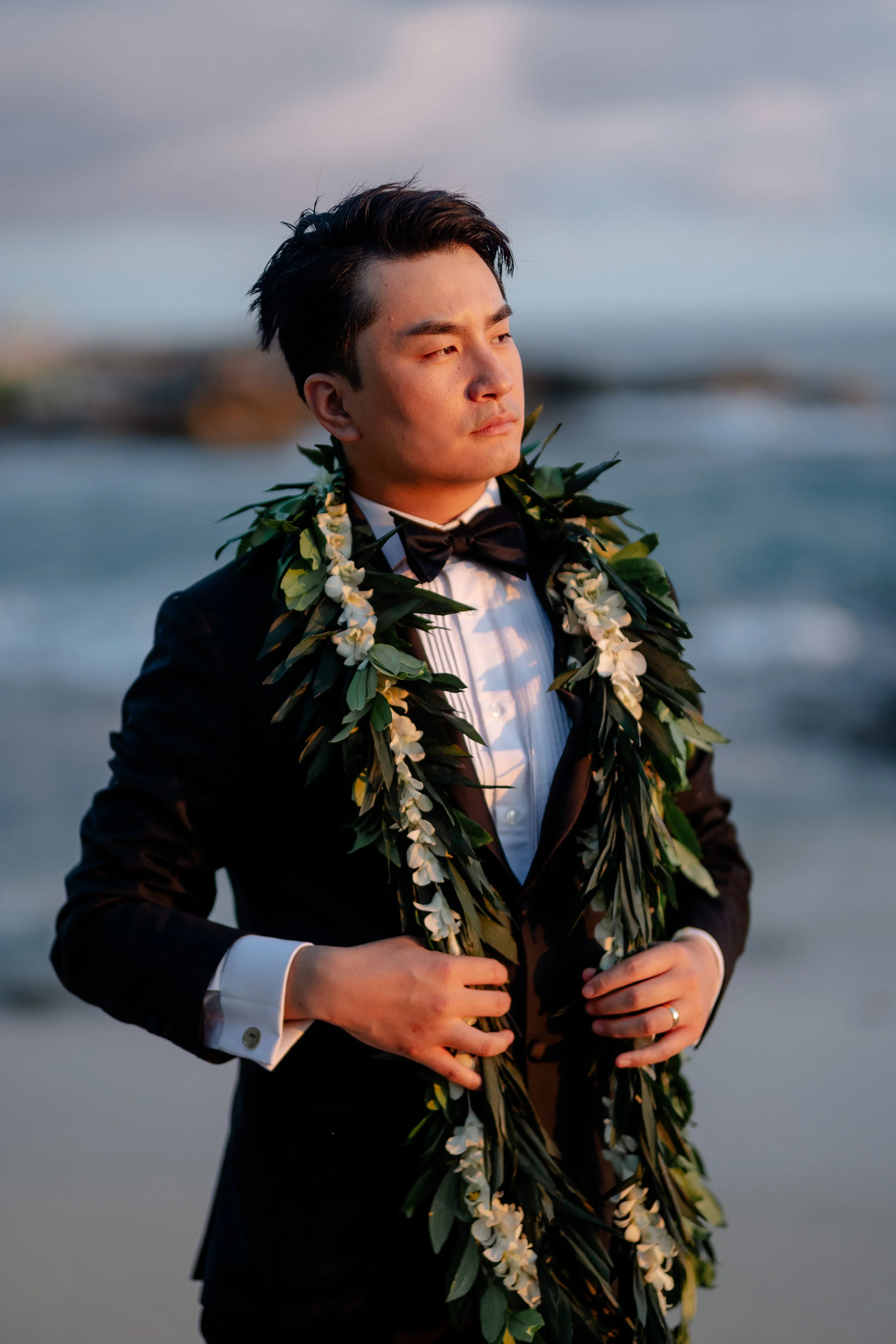portrait of groom wearing a Hawaiian lei