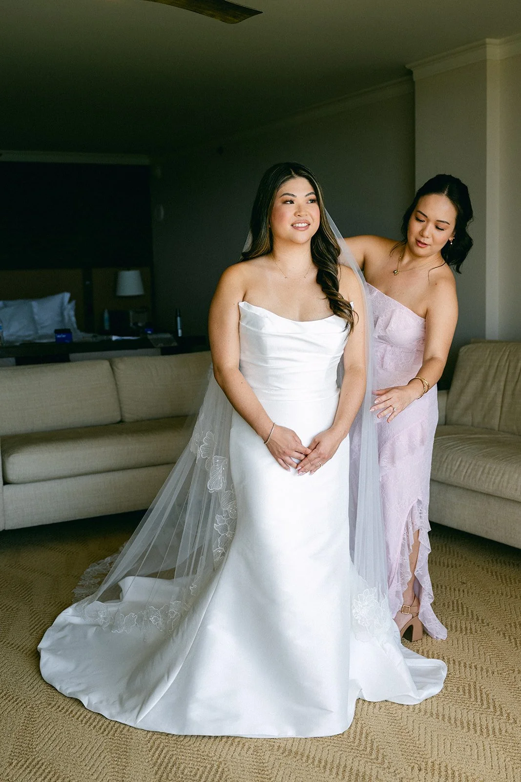 bridesmaid helping bride get ready