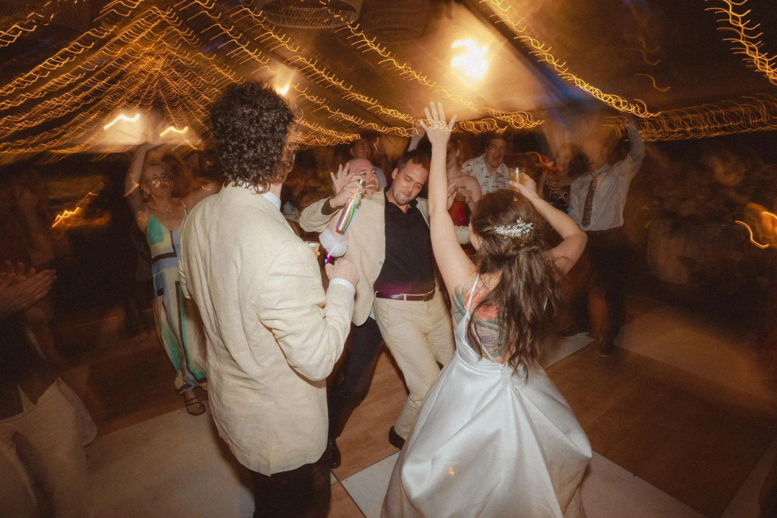 bride and groom dancign with wedding guests