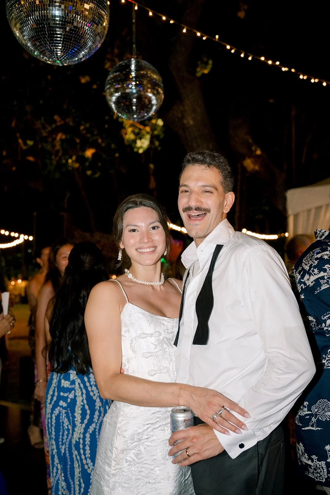 bride and groom at night with disco balls