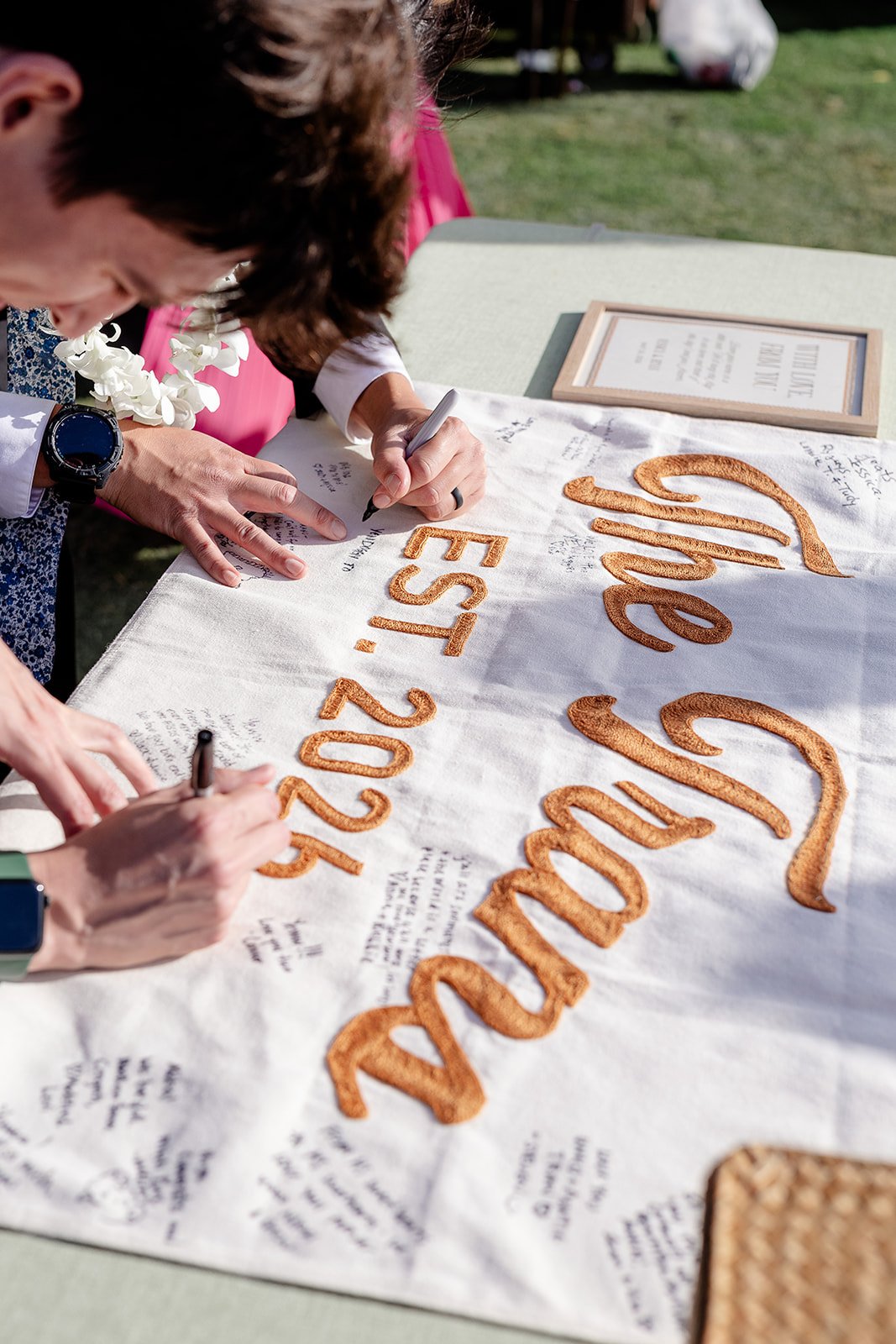 people signing wedding flag