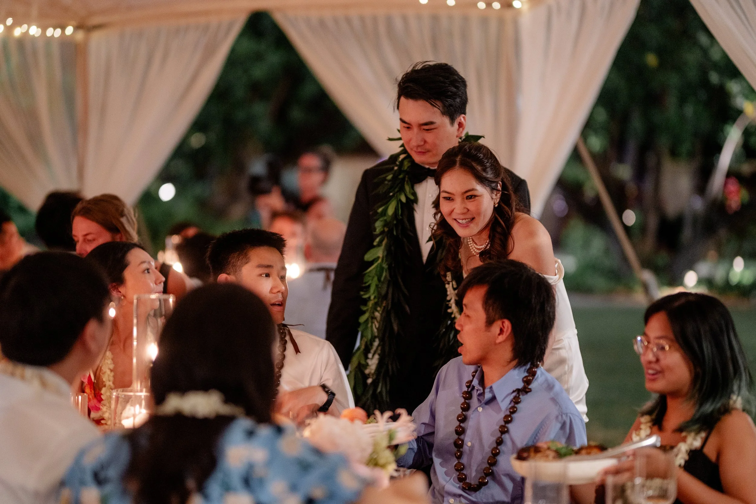bride ad groom talking with guests during dinner