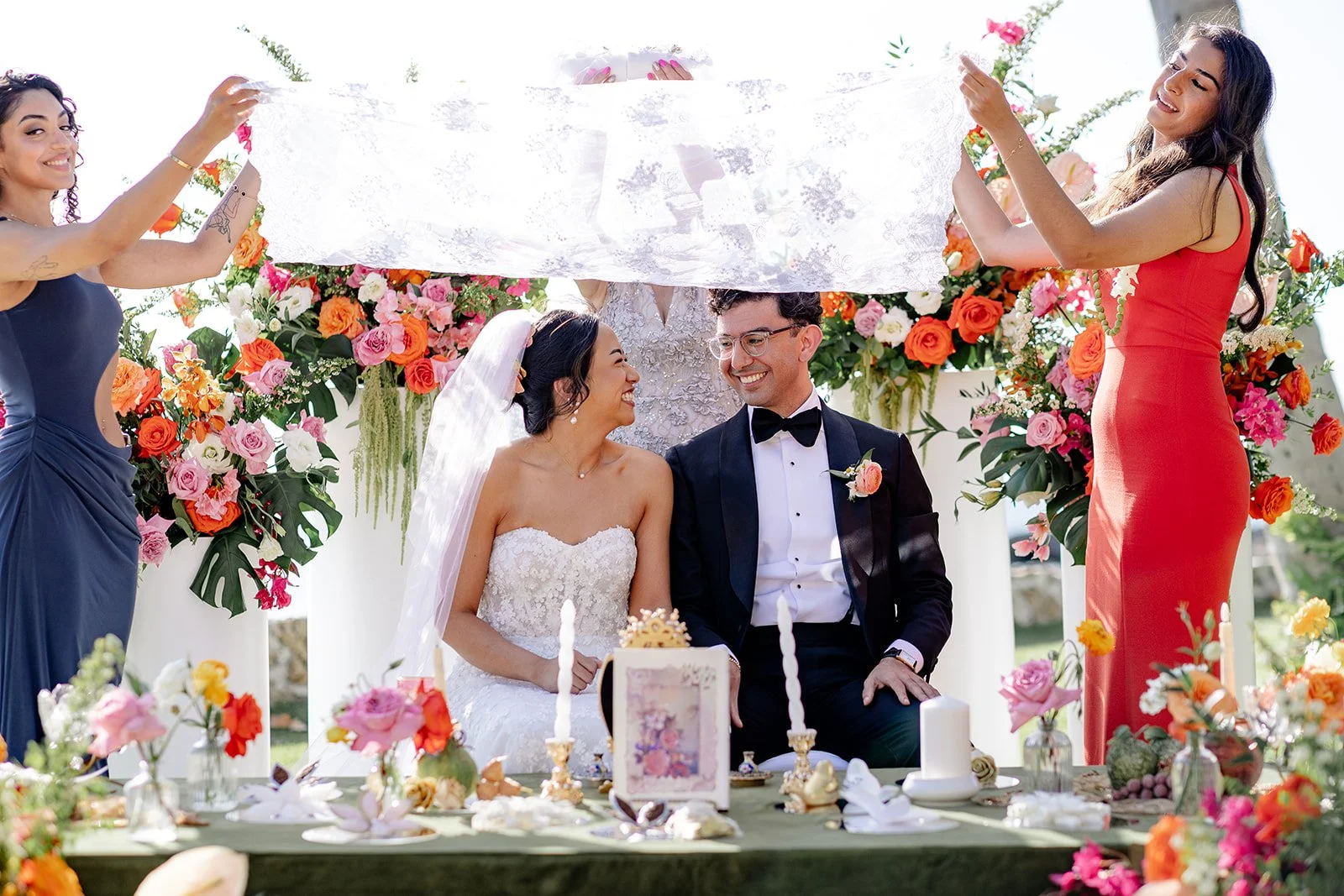 bride and groom smiling at each other during ceremony