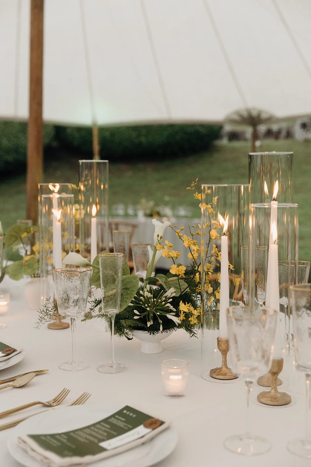 yellow and green floral center piece with gold candles