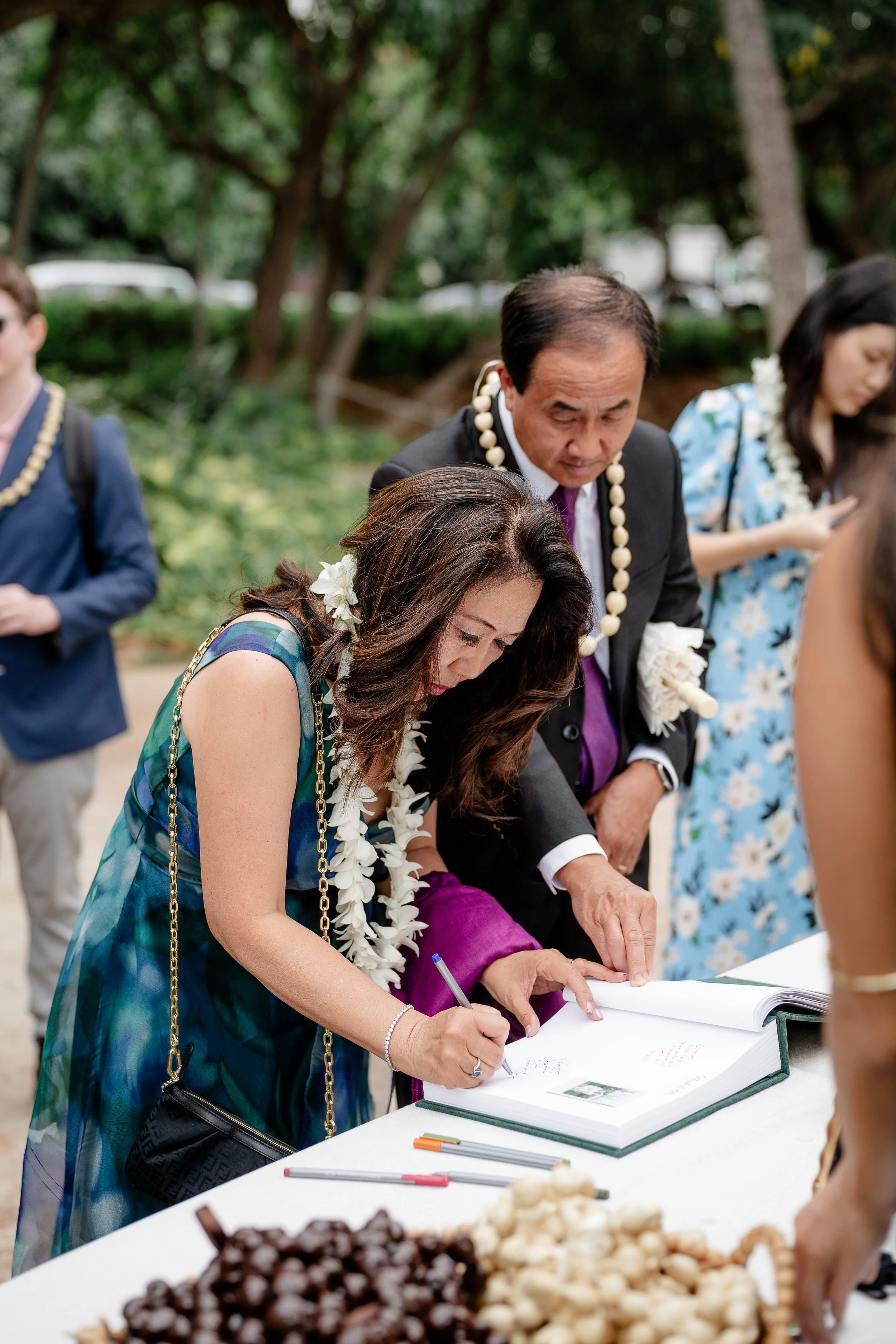 woman and man signing guestbook