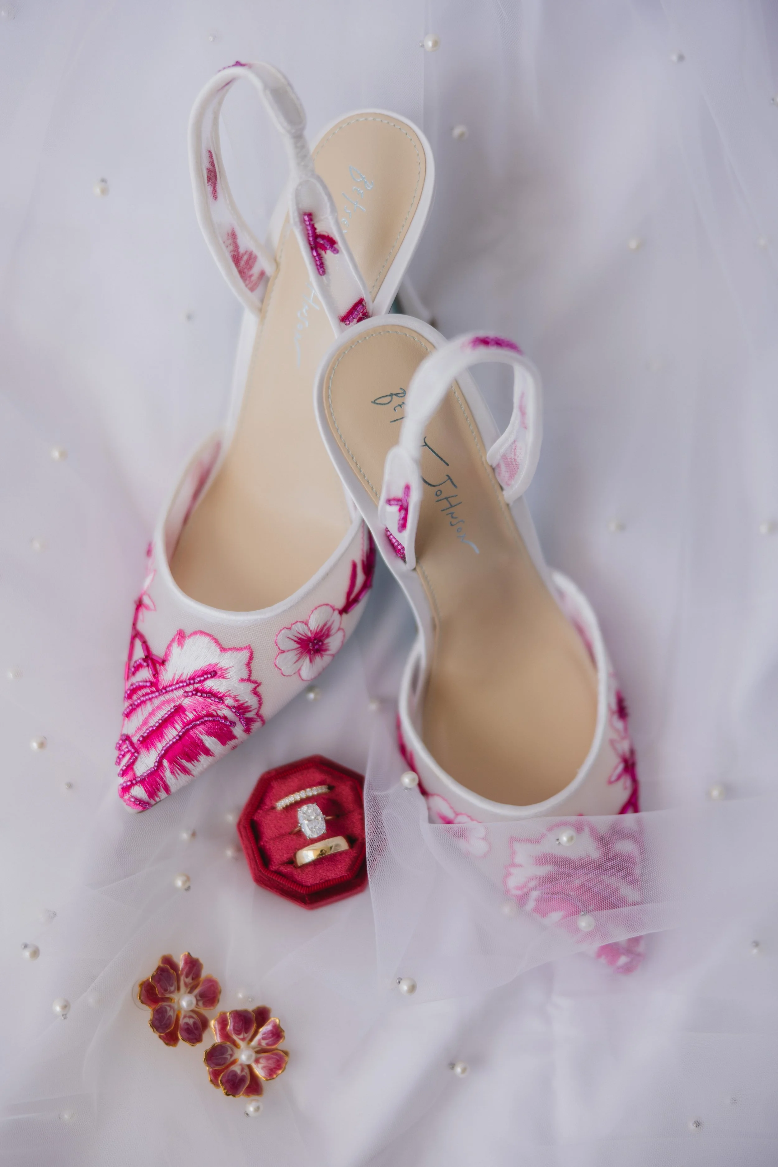 pink floral heels with wedding rings