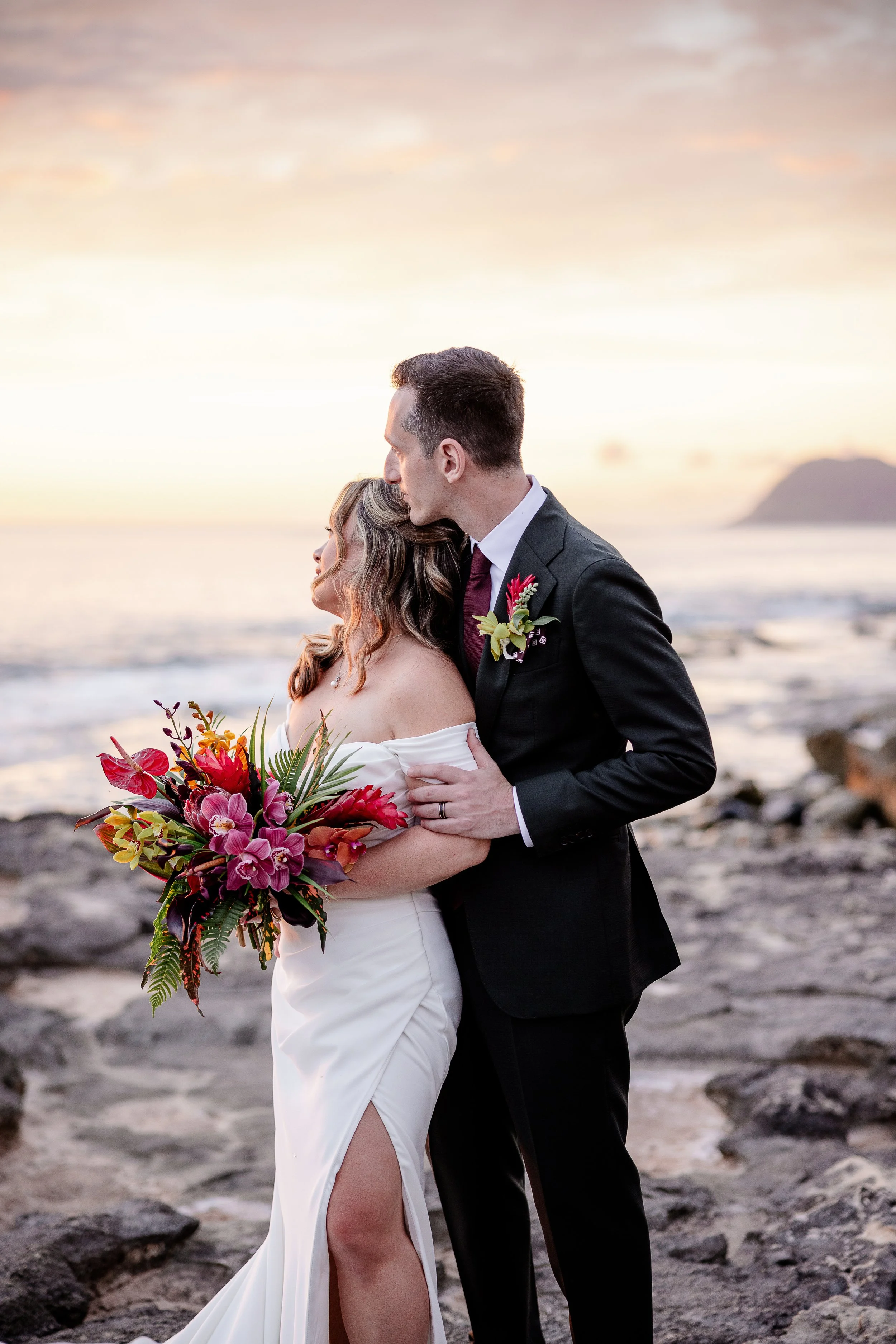 bride and groom on a beach in Hawai'i at sunset