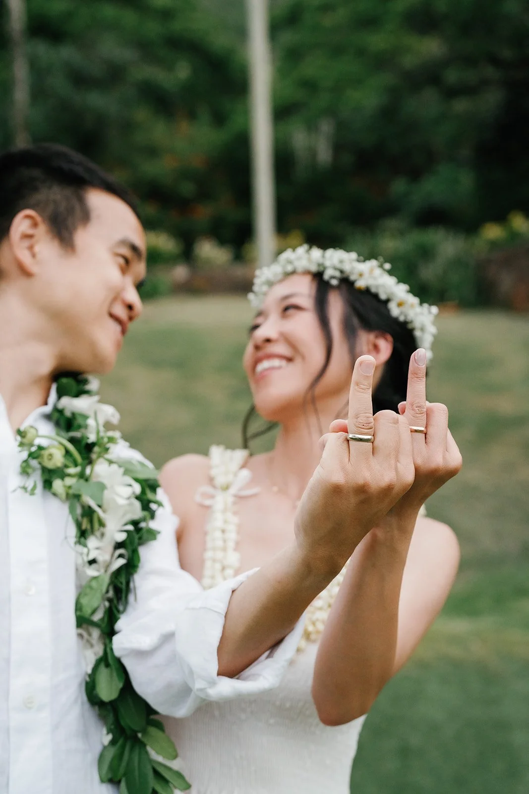 Bride and groom show off their wedding rings