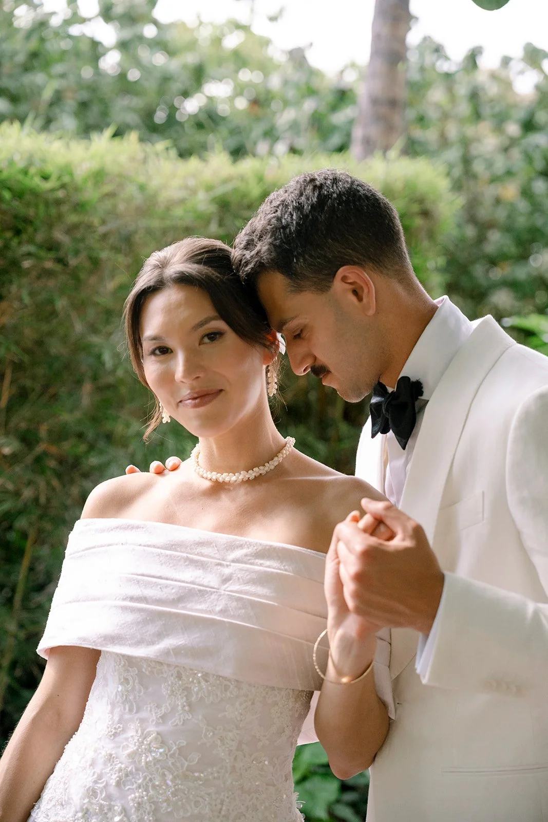 bride and groom posing and holding hands