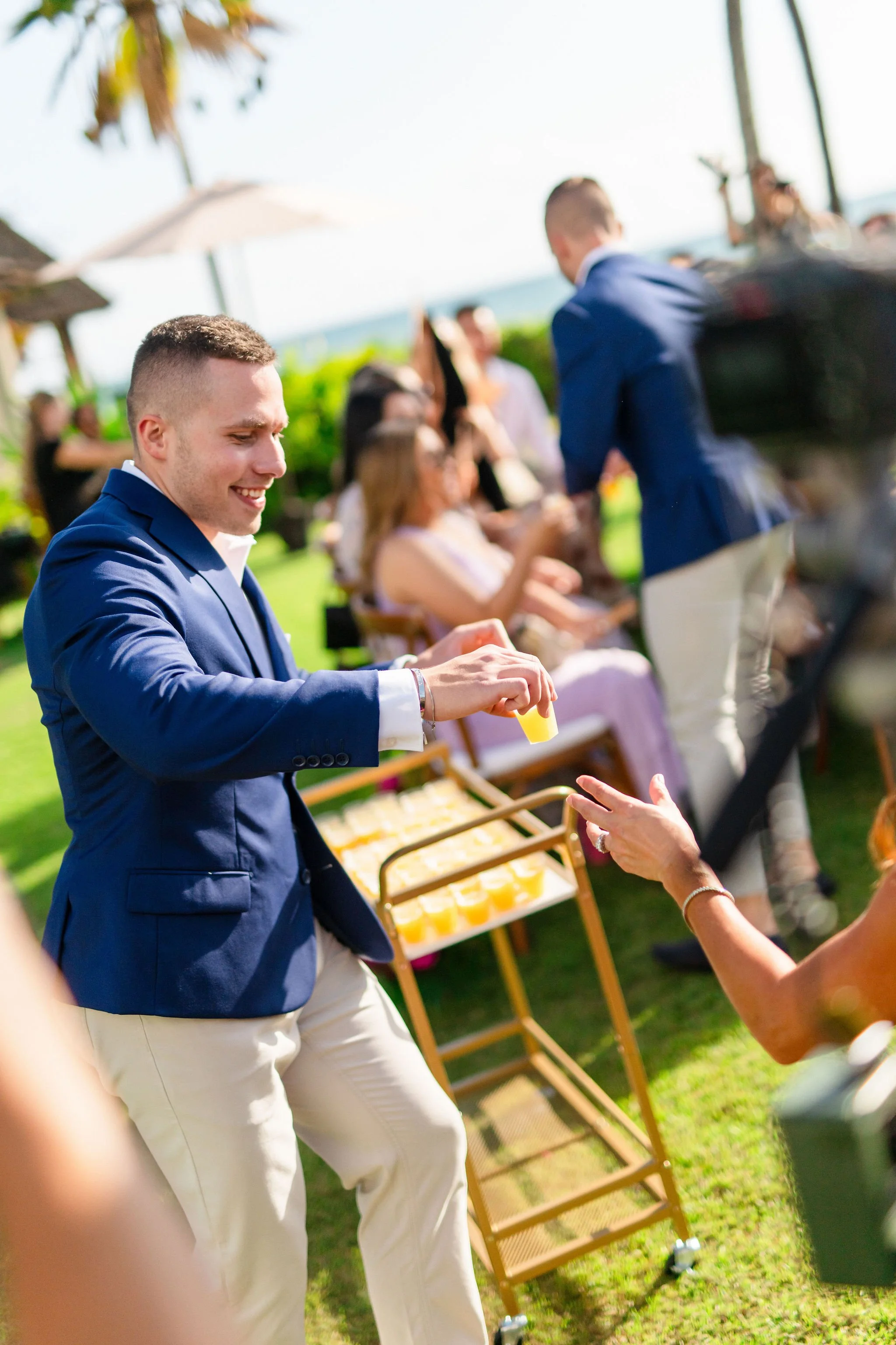 groomsmen passing out shots during wedding ceremony