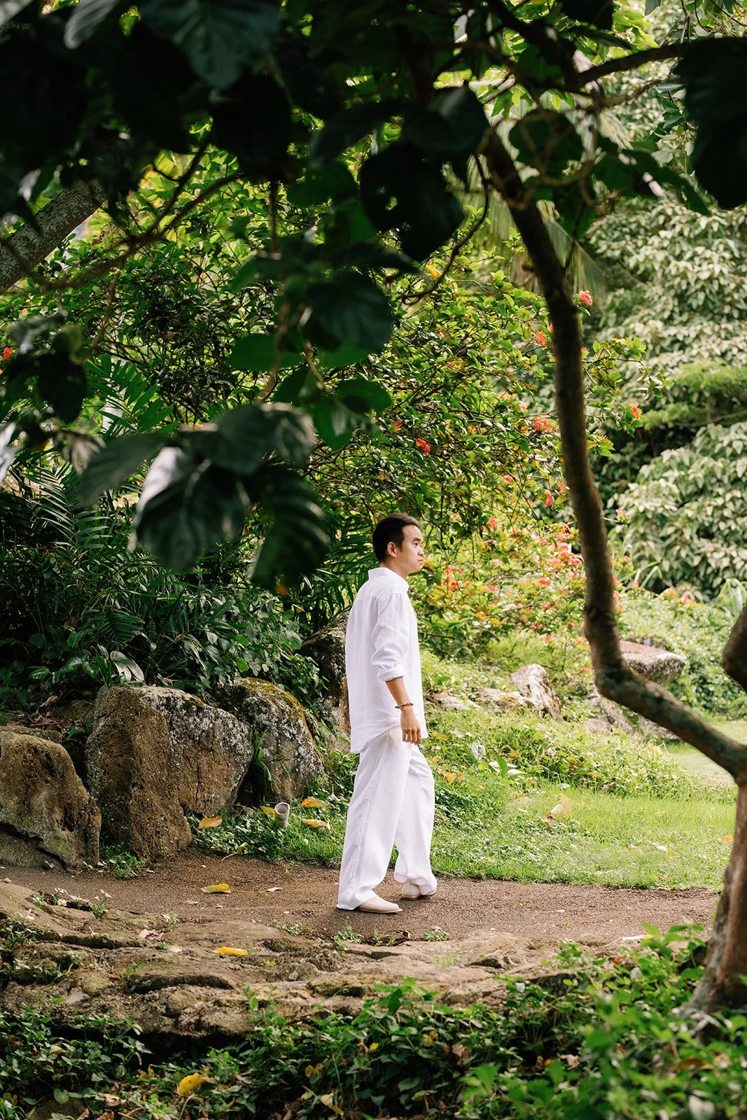 The groom in his wedding attire wearing all white